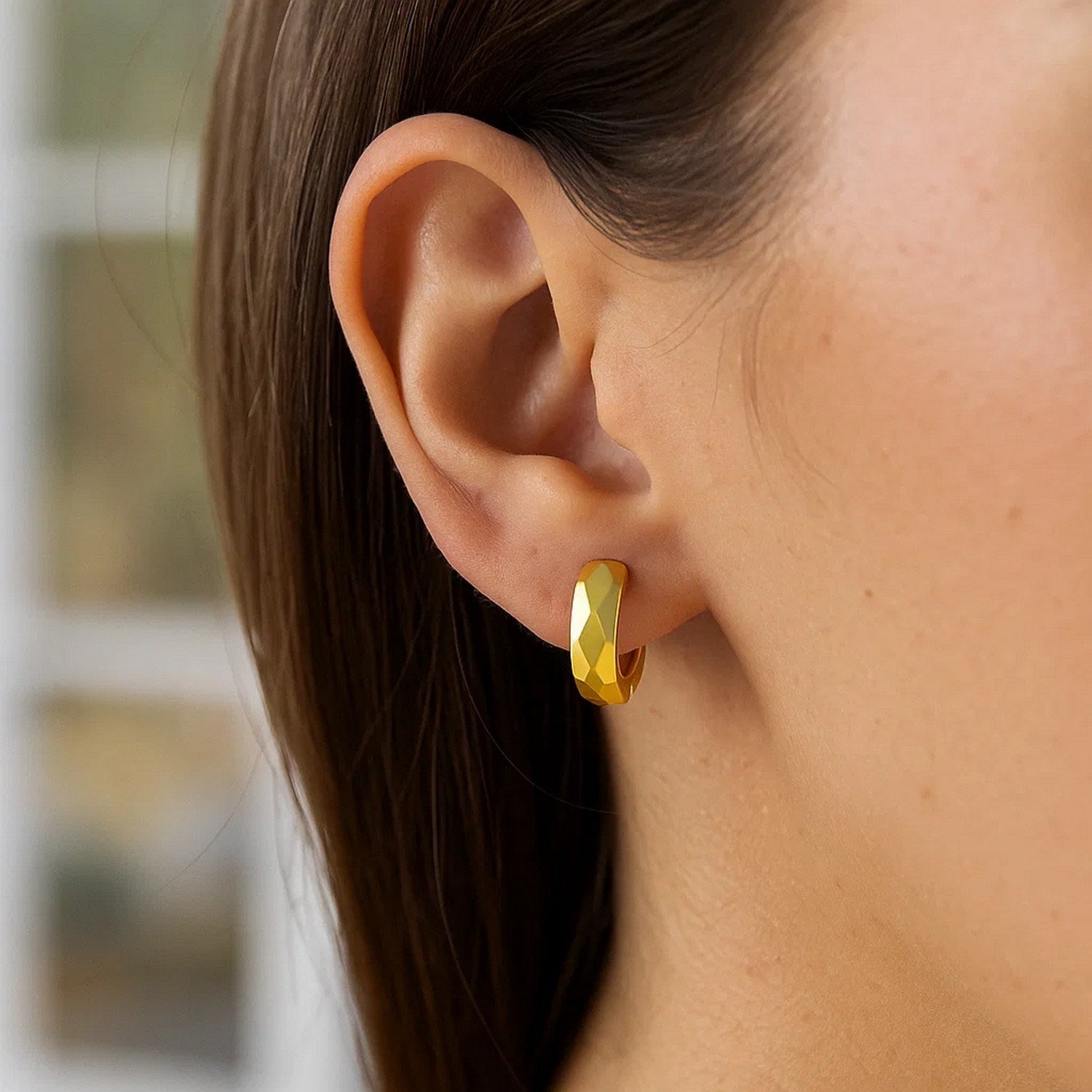 14K yellow gold diamond faceted huggie earrings showcasing modern elegance and exquisite craftsmanship.