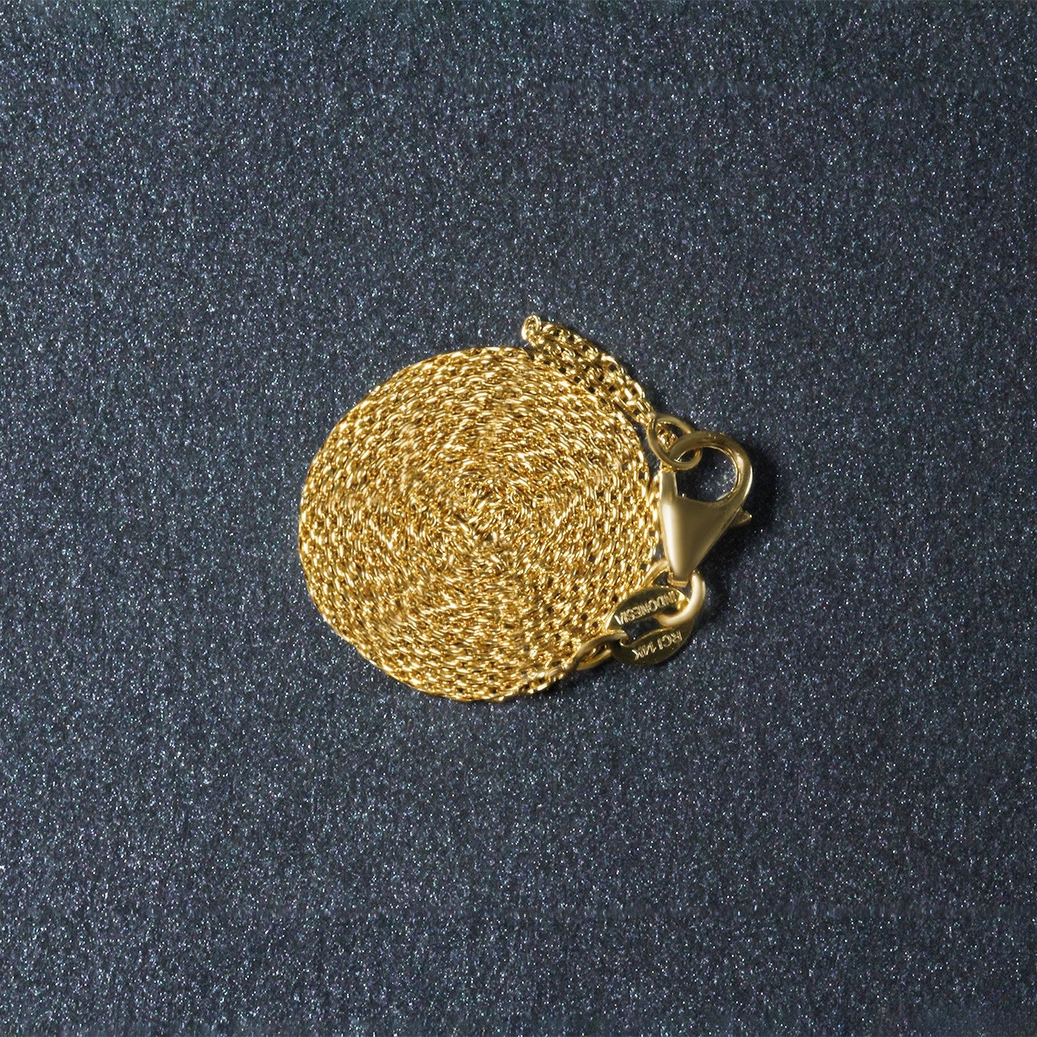 Elegant 18k yellow gold round cable link chain, showcasing a refined design with a luxurious shine.
