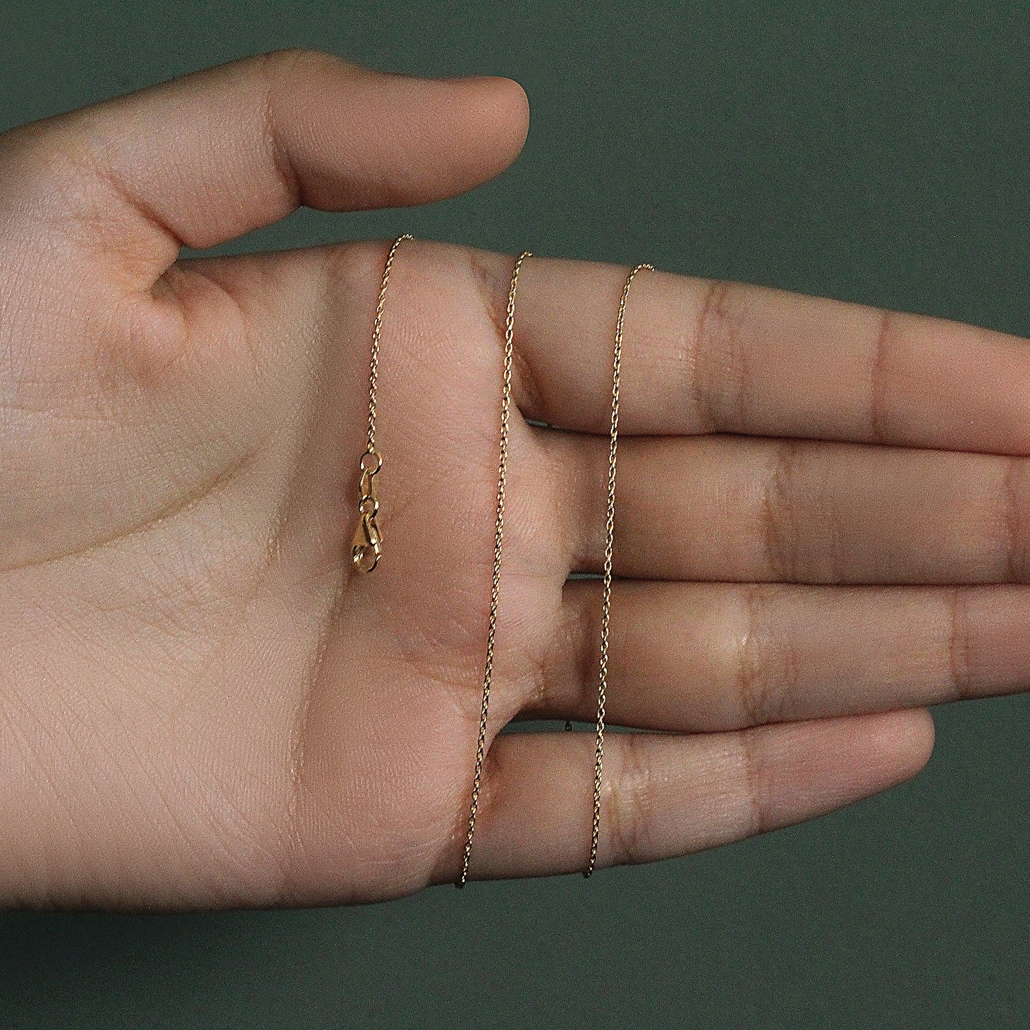 Elegant 18k yellow gold round cable link chain, showcasing a refined design with a delicate 0.97 mm thickness.