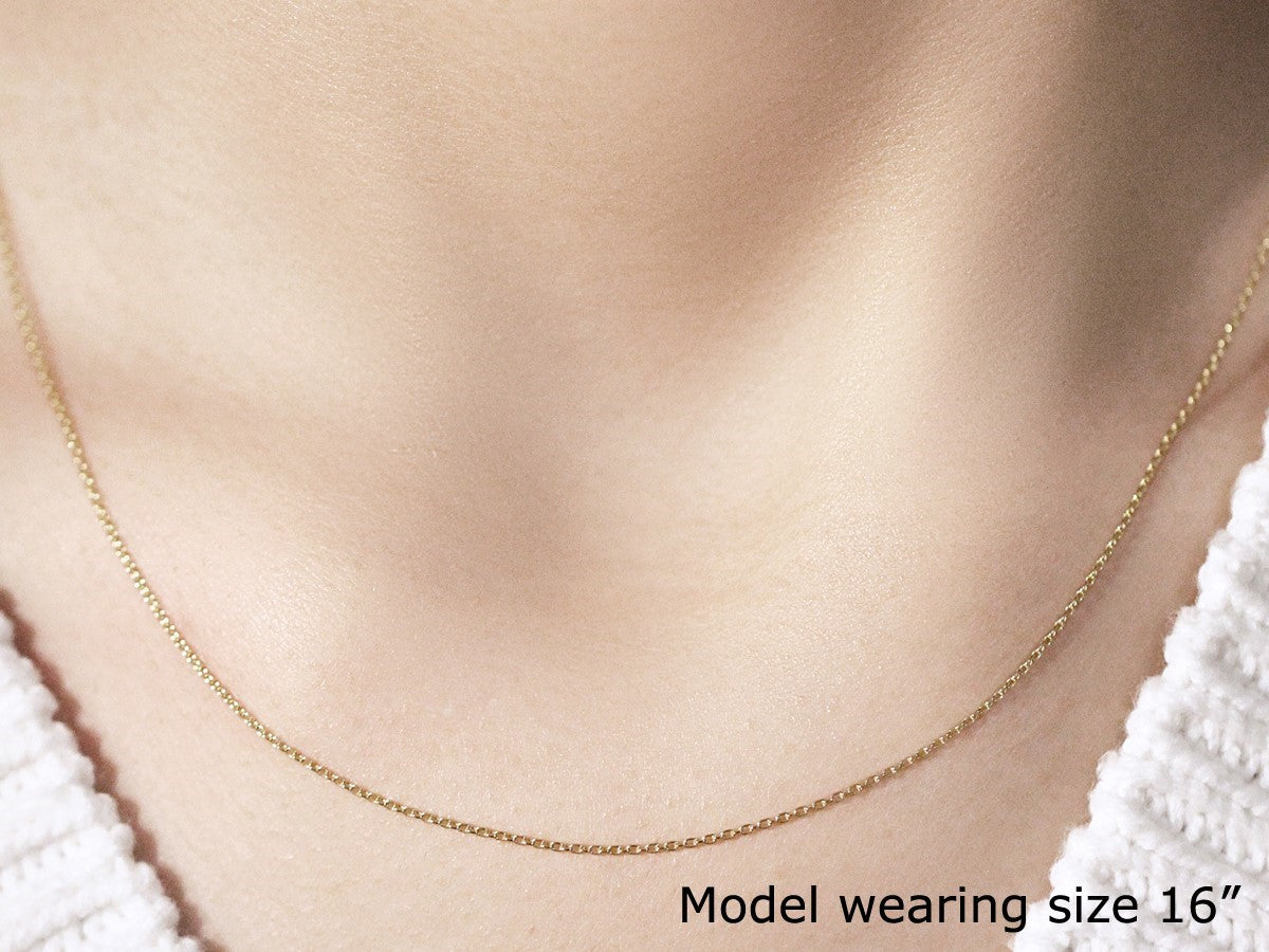 Elegant 18k yellow gold round cable link chain, showcasing refined craftsmanship and a timeless design.