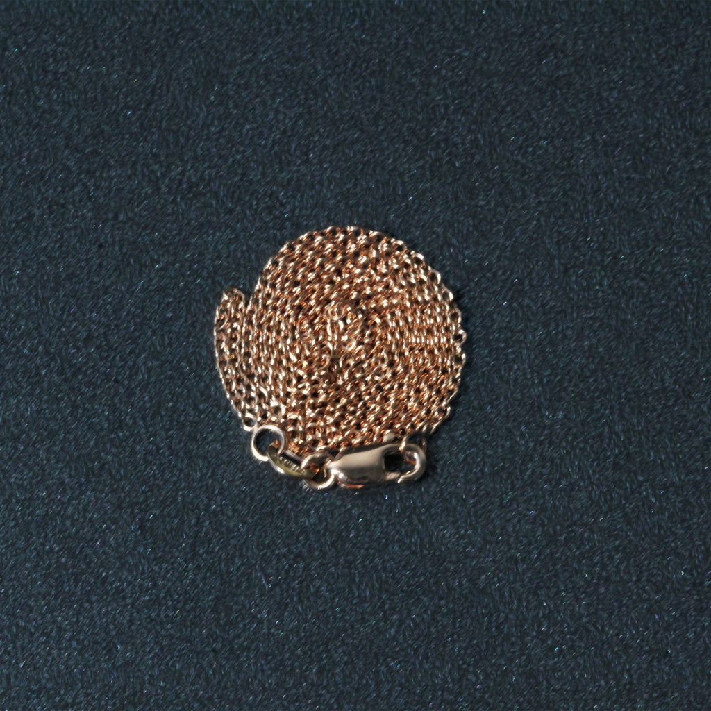 Elegant 14k rose gold round cable link chain, 1.25 mm, showcasing a refined and timeless design.