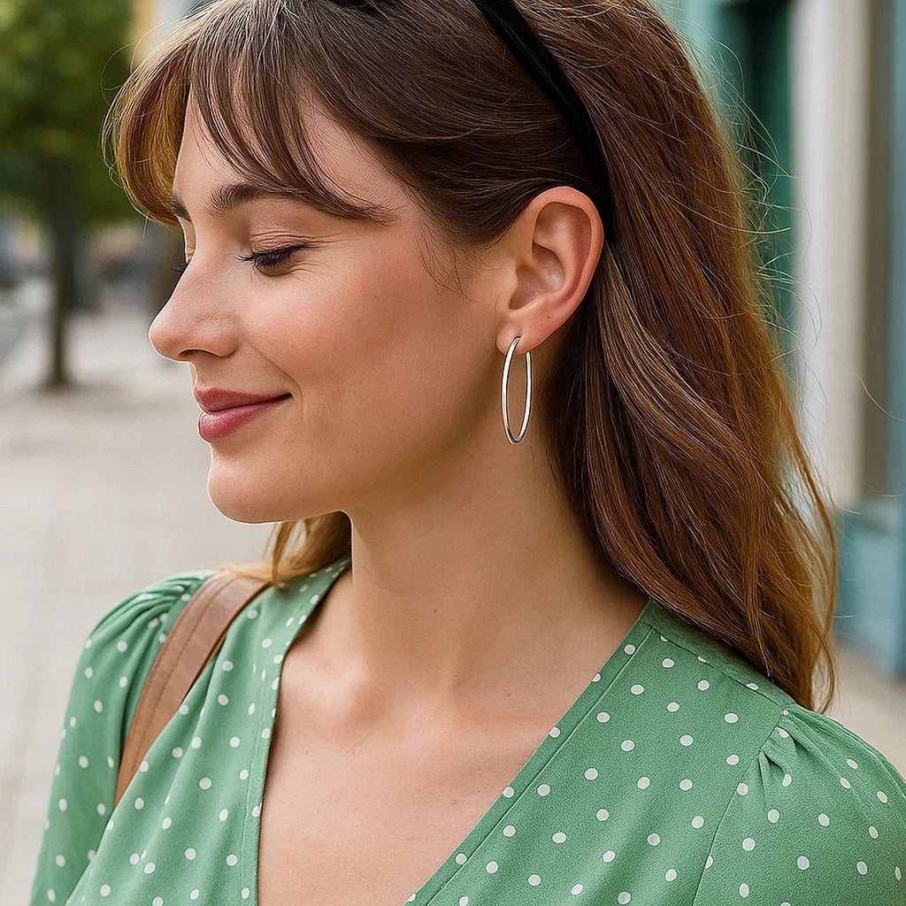 14k white gold polished slim oval hoop earrings, showcasing contemporary elegance and refined craftsmanship.