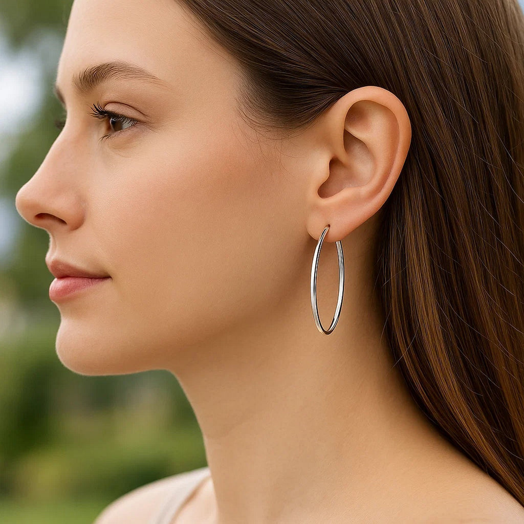 14k white gold polished slim oval hoop earrings, showcasing contemporary elegance and refined craftsmanship.