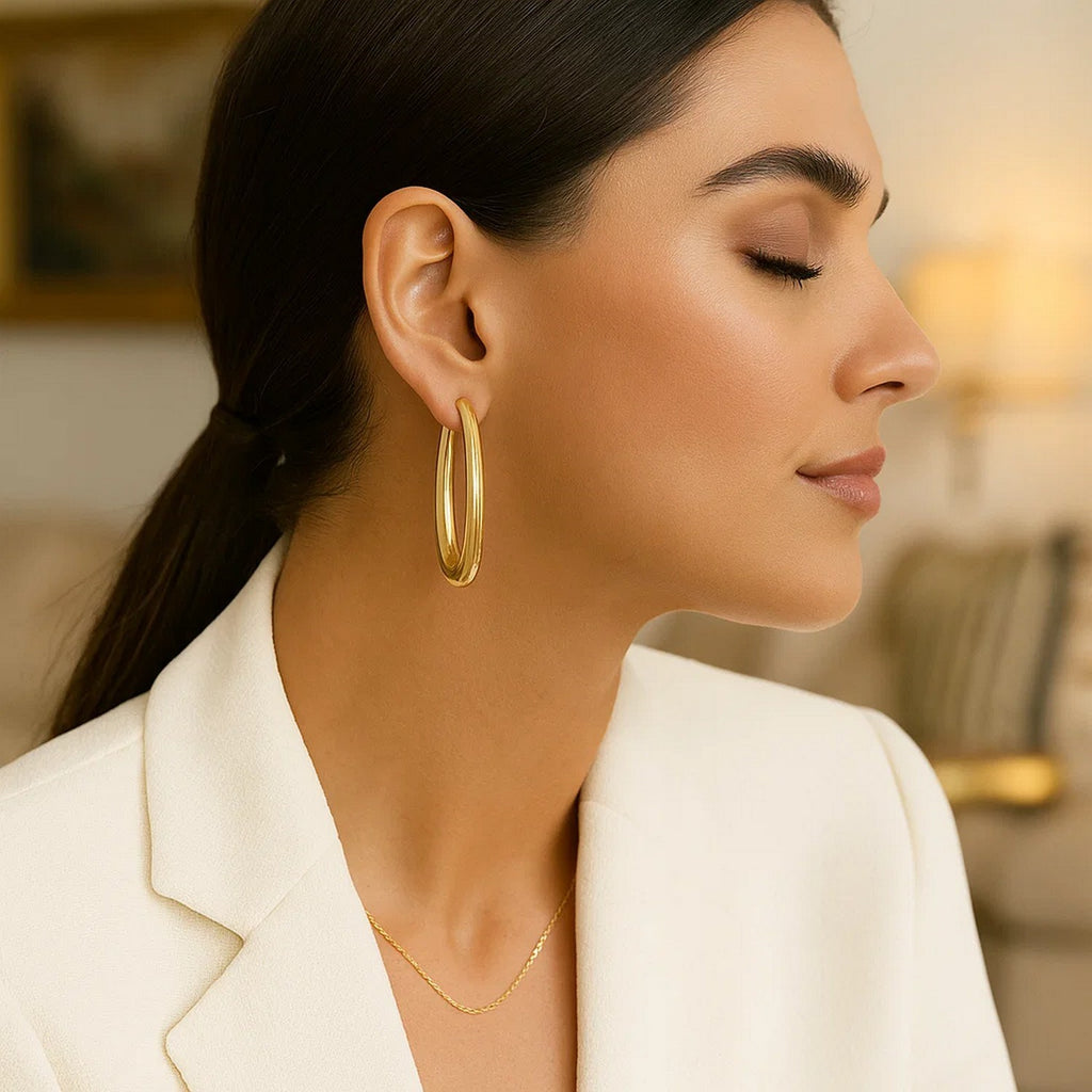 14k yellow gold elongated oval hoop earrings with a contemporary design, perfect for elegant occasions.
