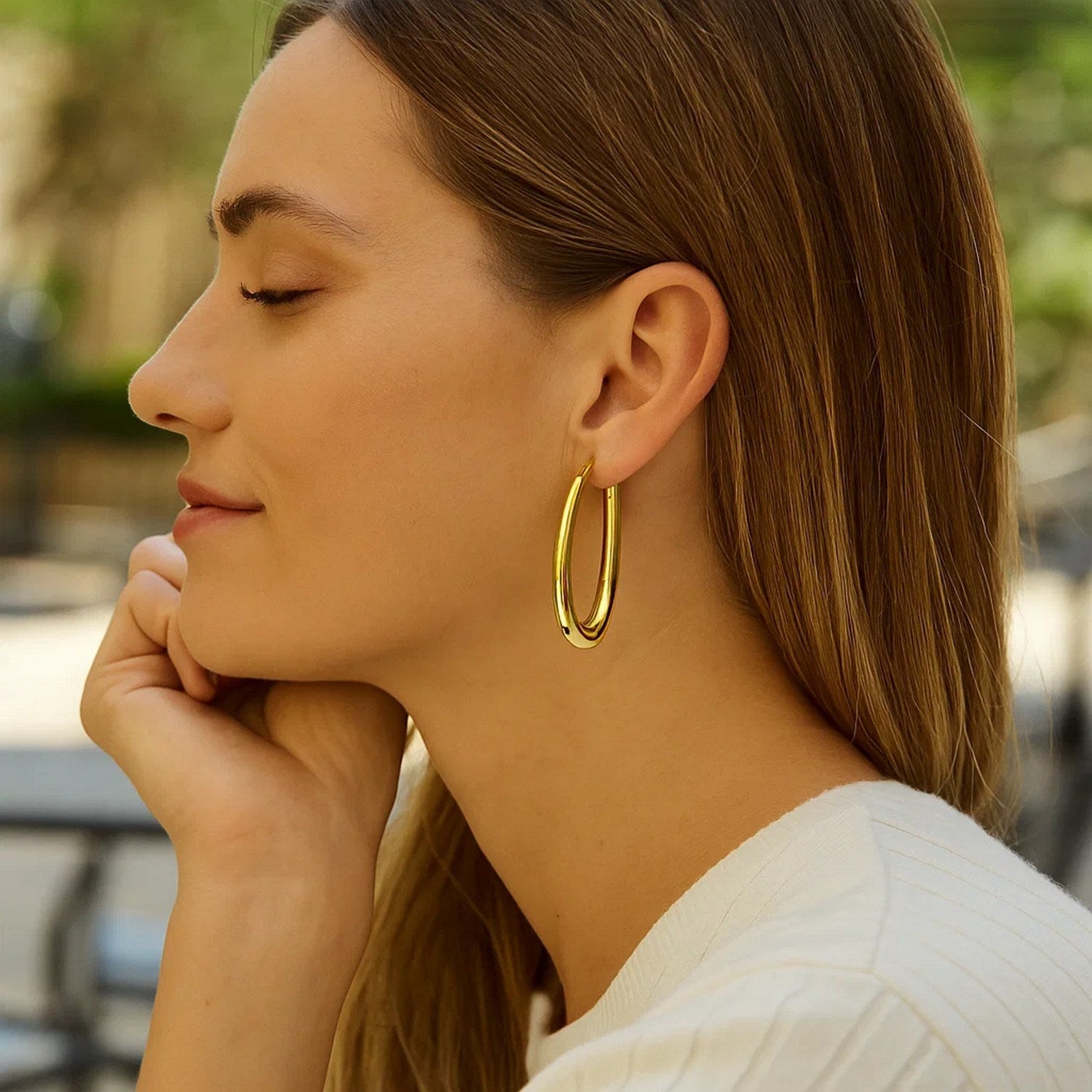 14k yellow gold elongated oval hoop earrings with a sleek contemporary design, perfect for elegant occasions.