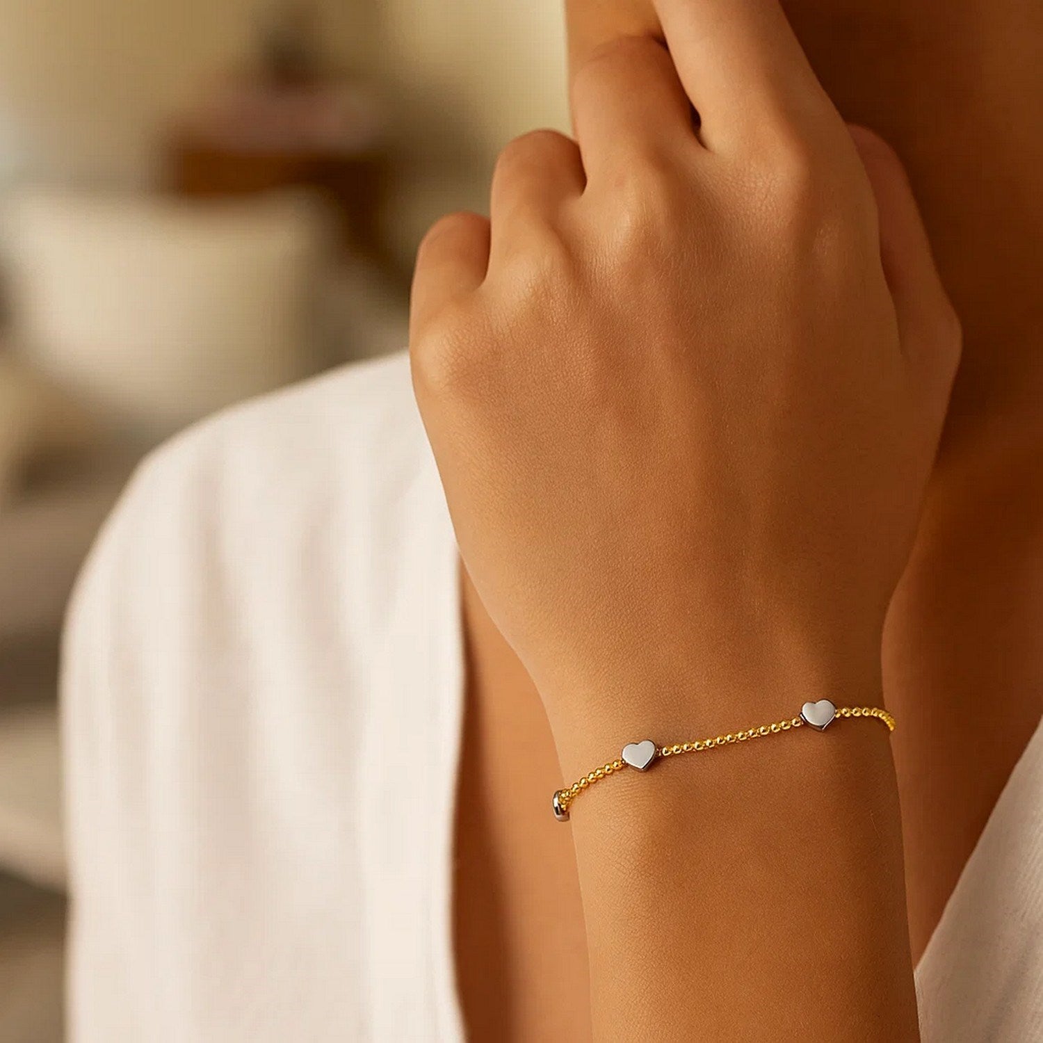 14K yellow and white gold heart bead bracelet adorned with sparkling diamonds, exuding elegance and luxury.