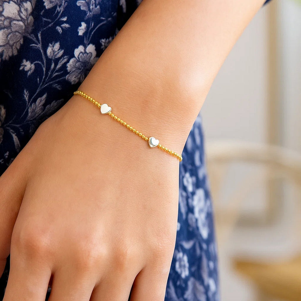 14k yellow and white gold heart bead bracelet adorned with sparkling diamonds for an elegant touch.