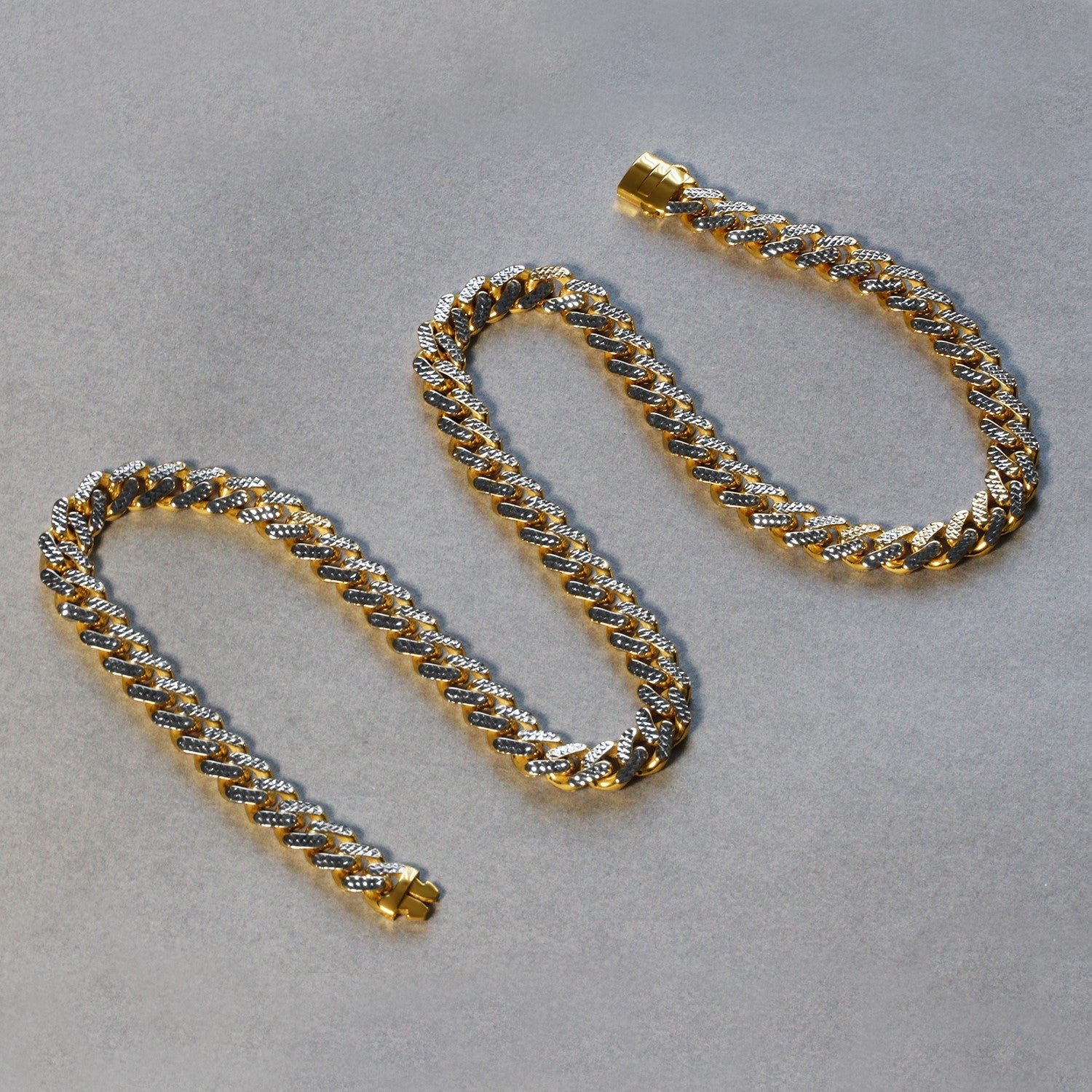 14k two-tone gold Miami Cuban chain necklace featuring white pave diamonds in a modern design.