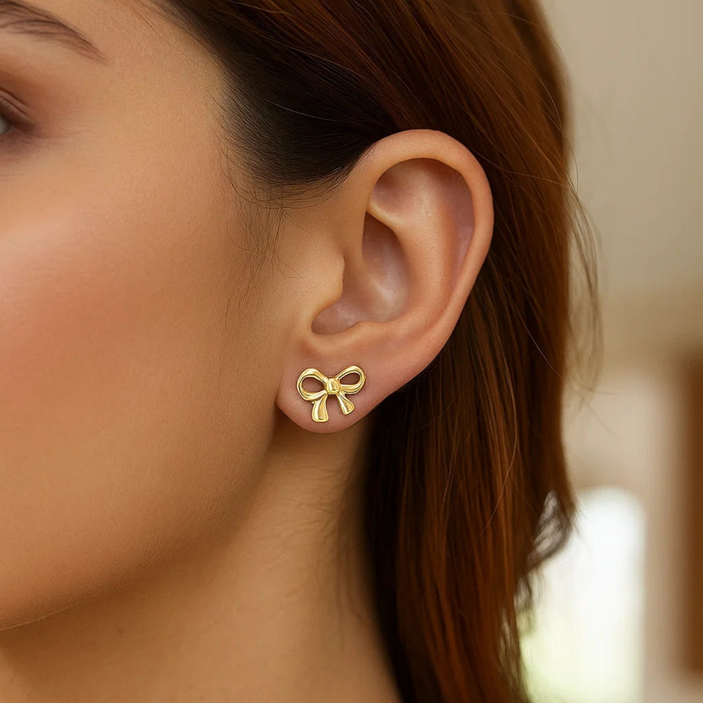 14k yellow gold bow style earrings featuring a modern design for a luxurious touch to any ensemble.