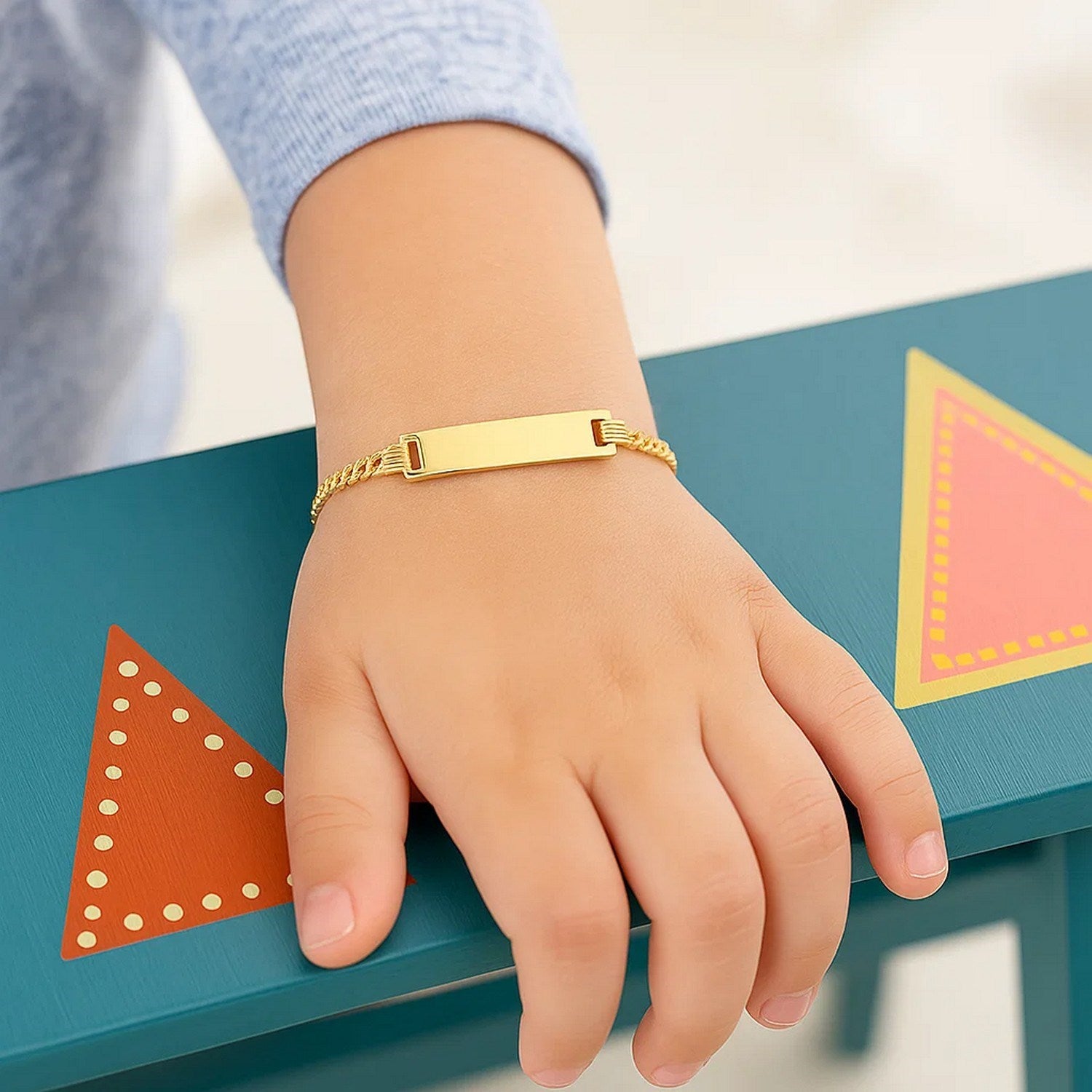 14k yellow gold curb link children's ID bracelet featuring a modern design and secure clasp for stylish wear.