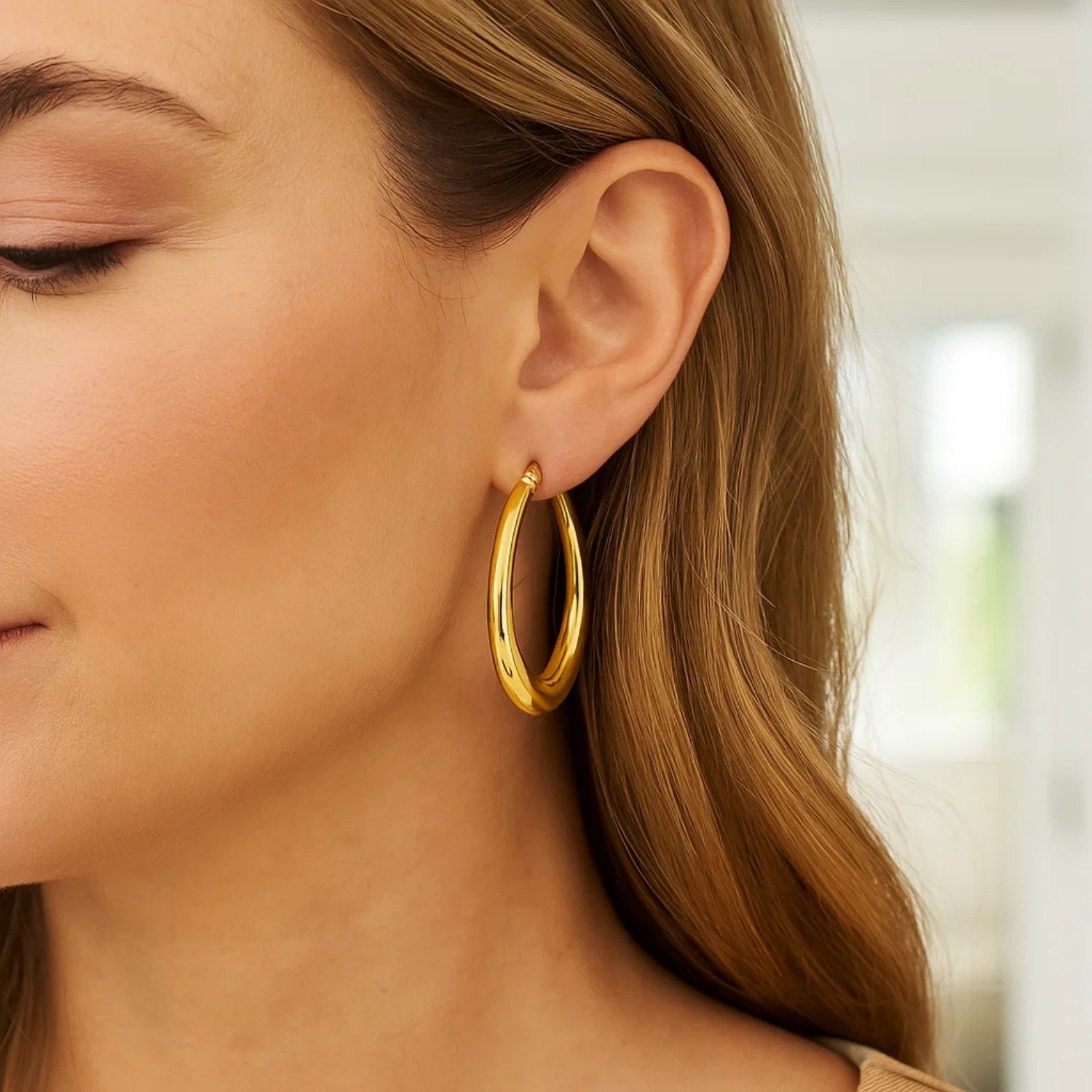 14K yellow gold oval electroform hoop earrings, showcasing a classic design with a luxurious finish.