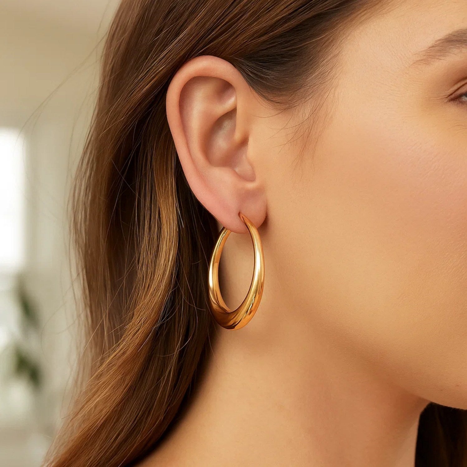 14K yellow gold oval electroform hoop earrings showcasing a classic, elegant design for timeless luxury.