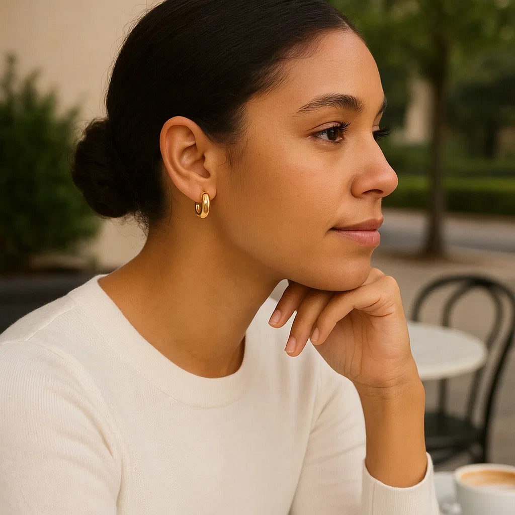 14k yellow gold polished small puffy hoop earrings with a modern design, perfect for elegant everyday wear.