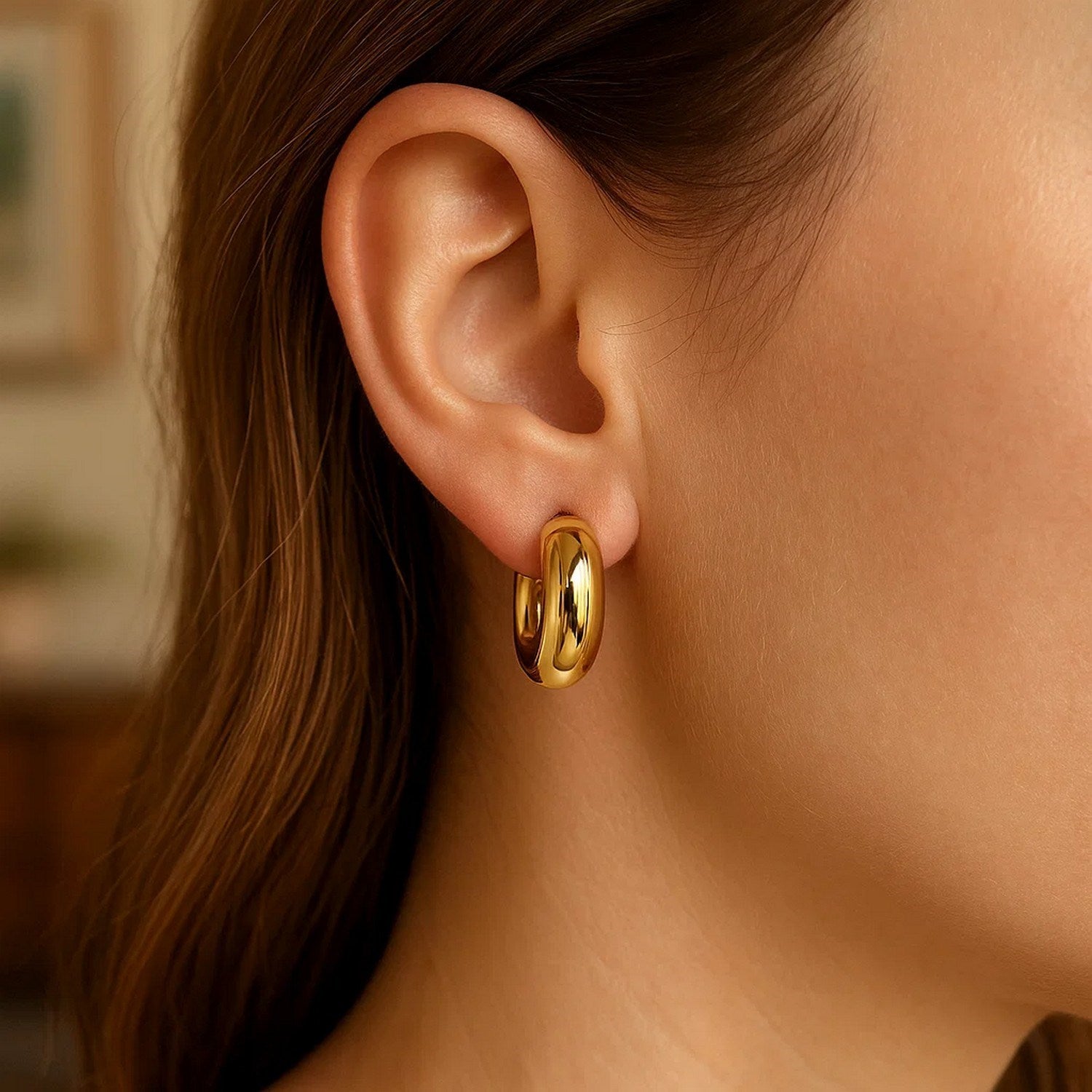 14k yellow gold polished small puffy hoop earrings with a modern design, perfect for elegant everyday wear.