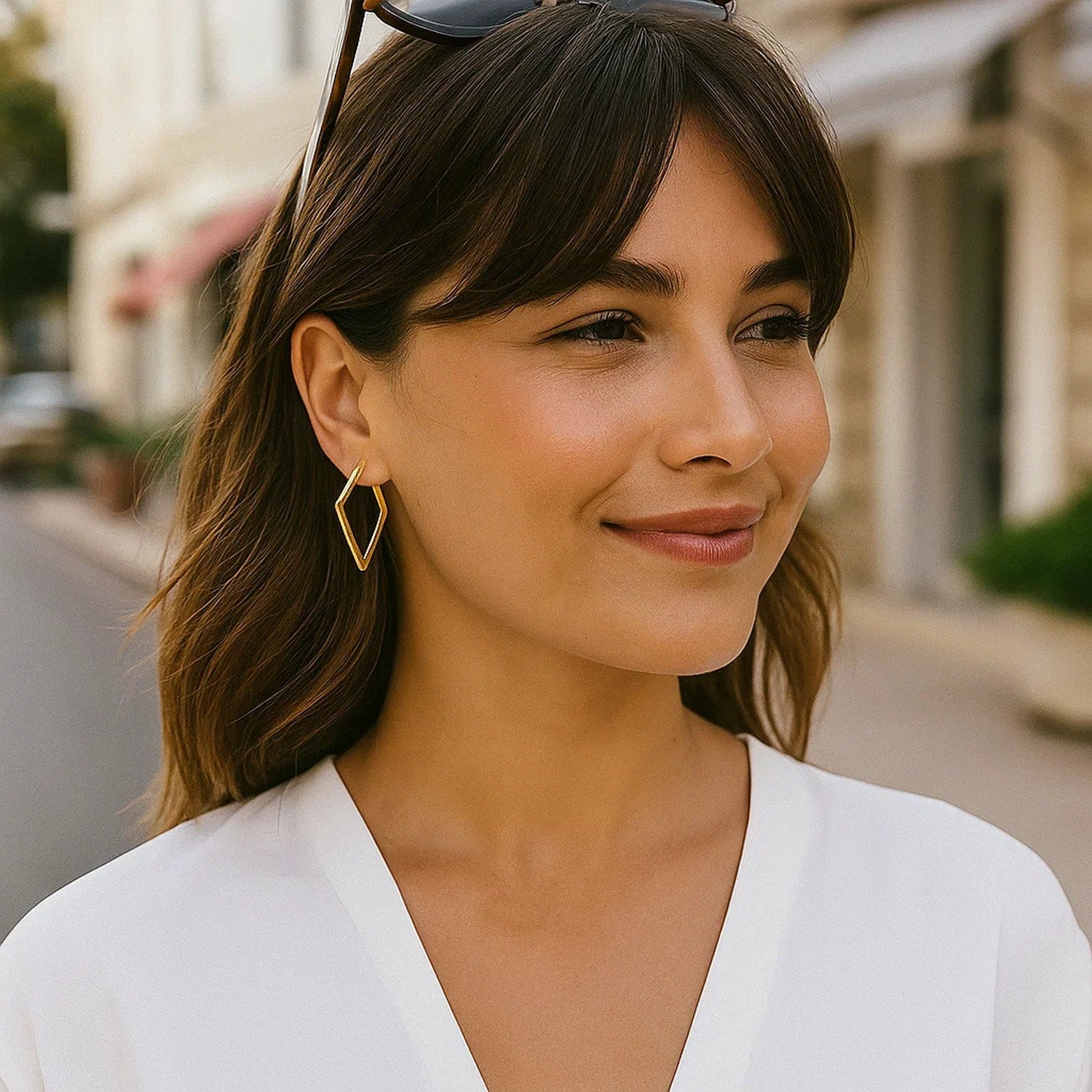 14K yellow gold hoop earrings adorned with sparkling diamonds, embodying classic elegance and timeless luxury.