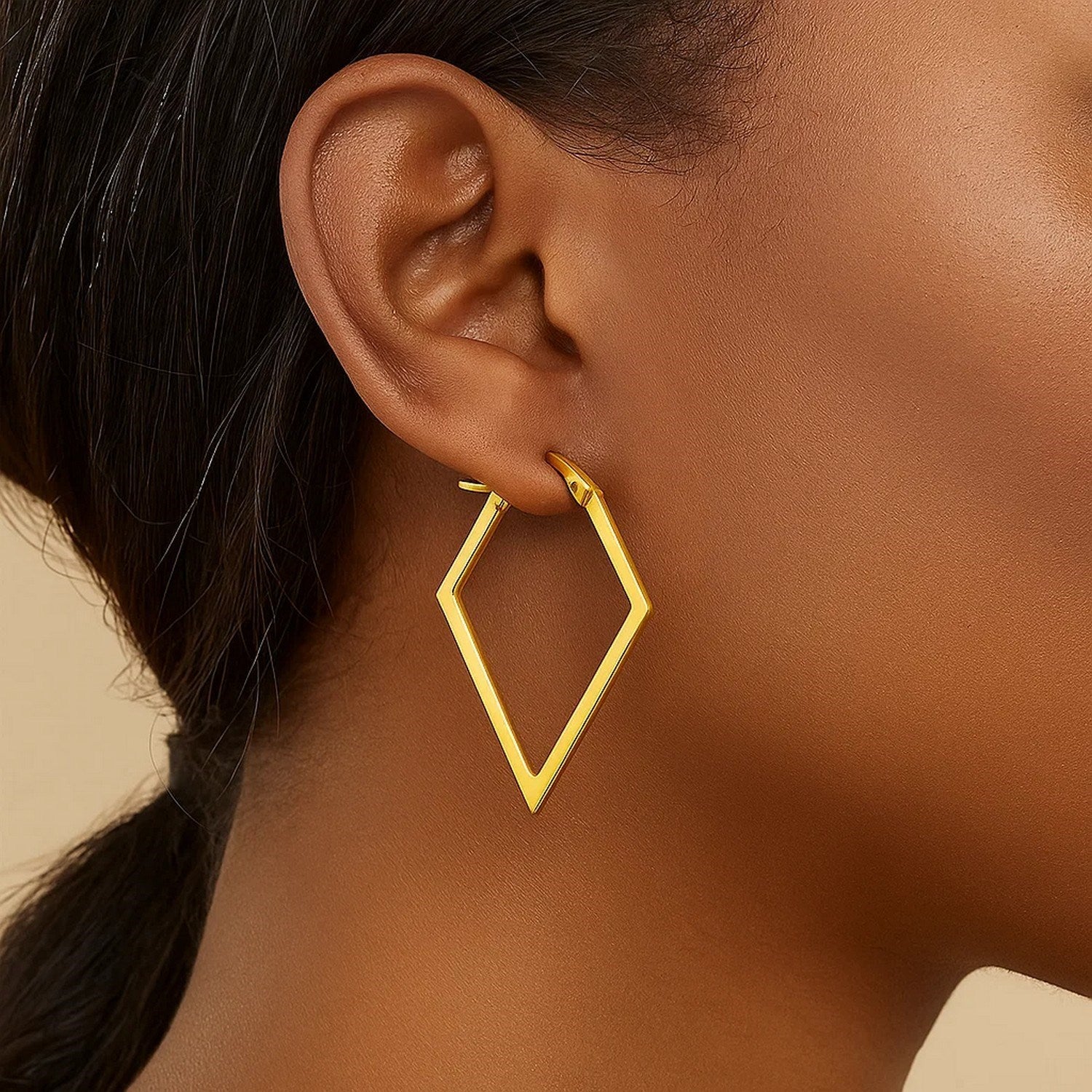 14k yellow gold hoop earrings adorned with sparkling diamonds, showcasing a timeless and elegant design.