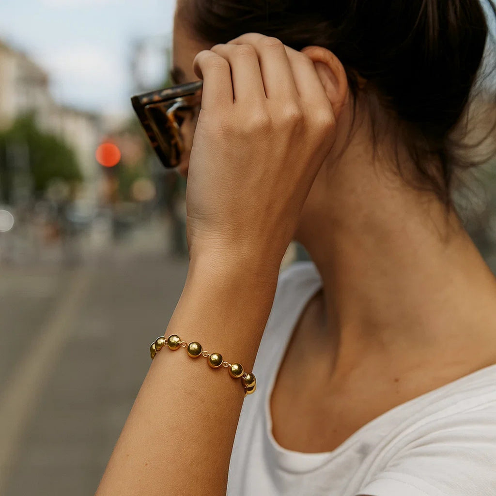 14k yellow gold polished pebble bead bracelet with elegant chain design, perfect for sophisticated styling.