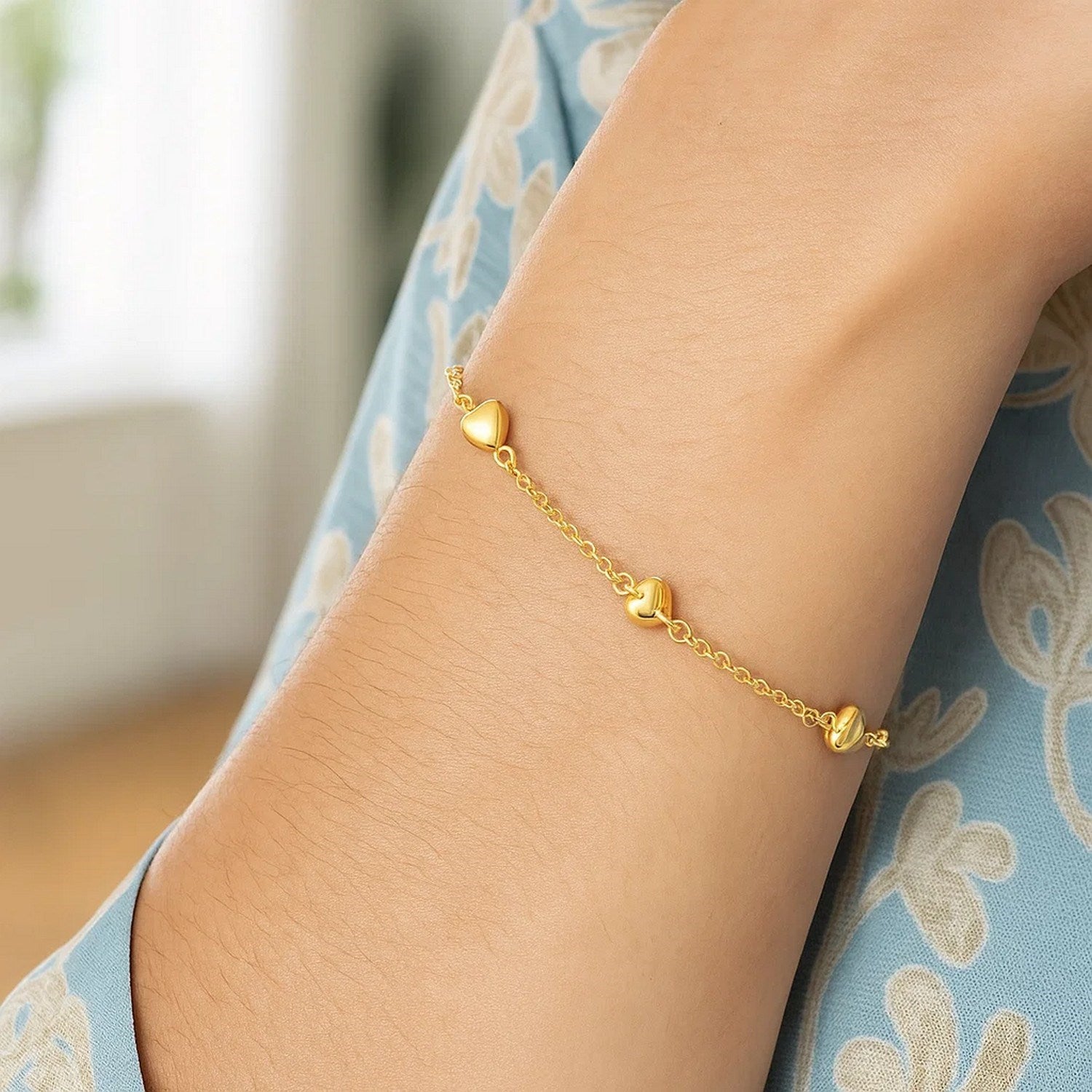 14k yellow gold rolo chain bracelet featuring elegant puffed heart stations, perfect for classic luxury style.