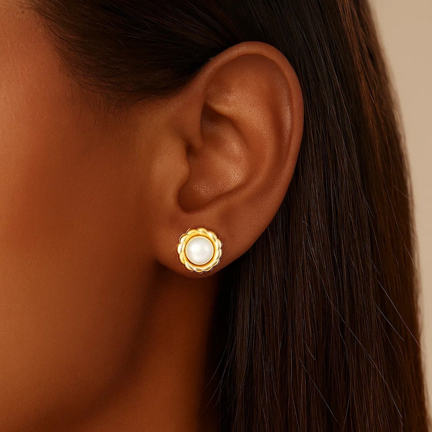 Elegant 14k yellow gold stud earrings featuring lustrous pearls in a delicate flower design.