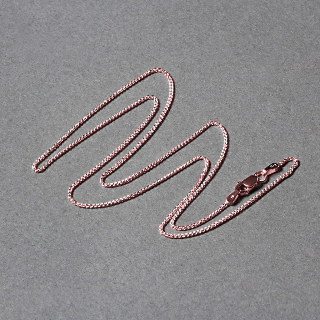 Elegant 14k rose gold round wheat chain, 1.00 mm, showcasing a refined design perfect for layering or standalone wear.