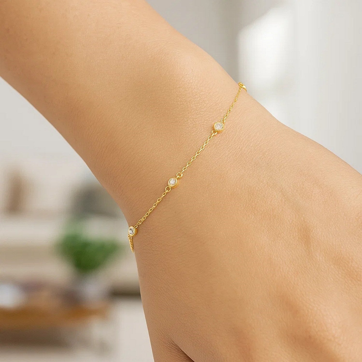 14k yellow gold modern bracelet featuring diamond stations, elegantly designed with a delicate chain for luxury appeal.