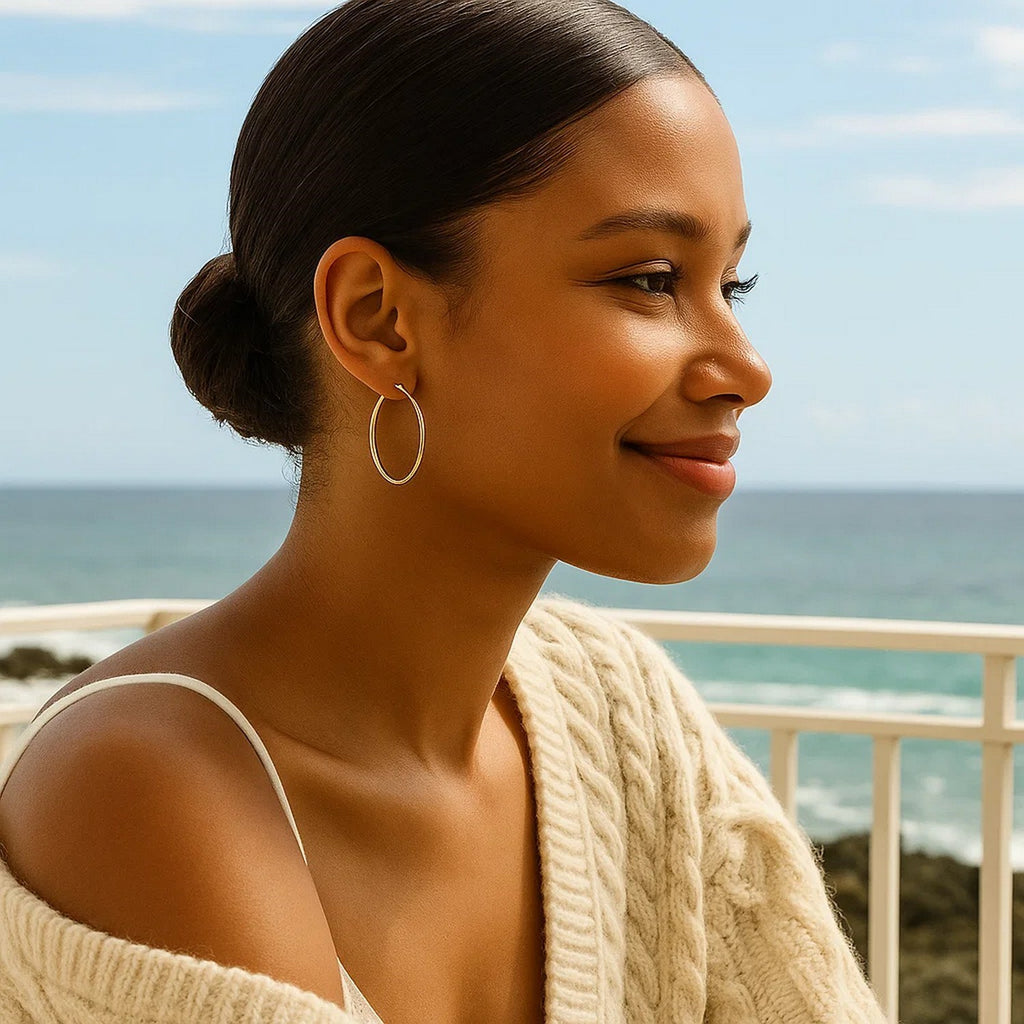 Elegant 14k yellow gold polished hoop earrings showcasing a timeless design, perfect for any luxury occasion.