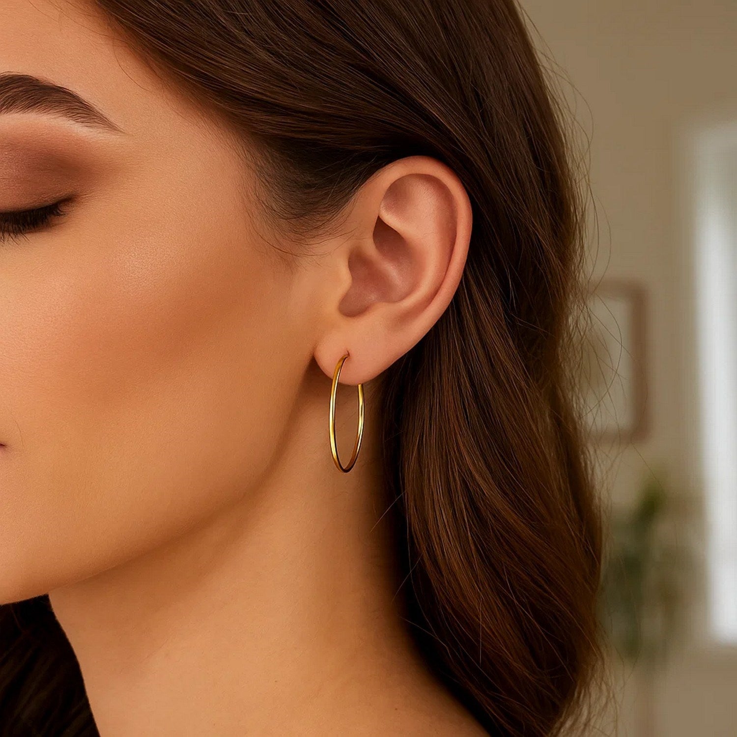 14k yellow gold polished hoop earrings showcasing an elegant design, perfect for sophisticated occasions.