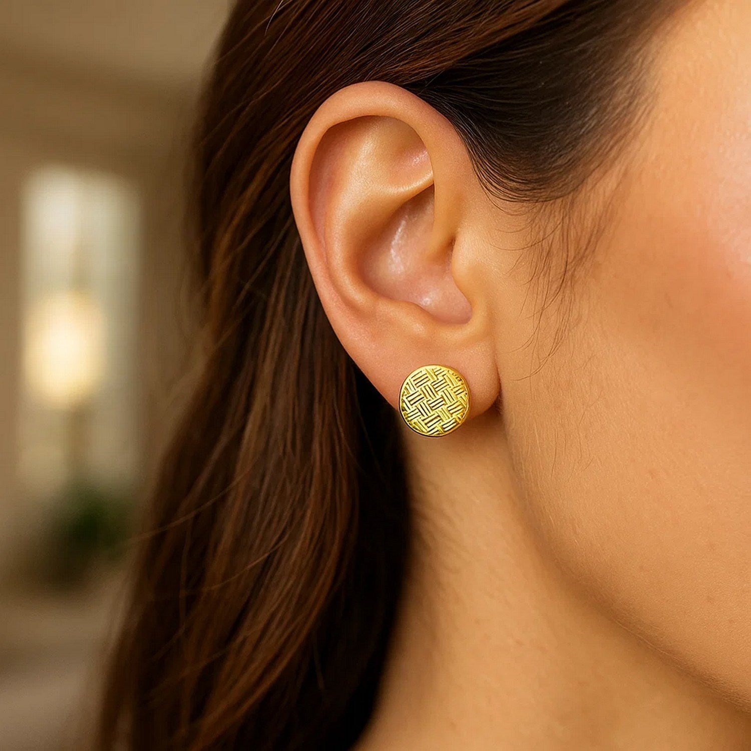 14k yellow gold textured circle earrings with a modern design, perfect for adding luxury to any outfit.