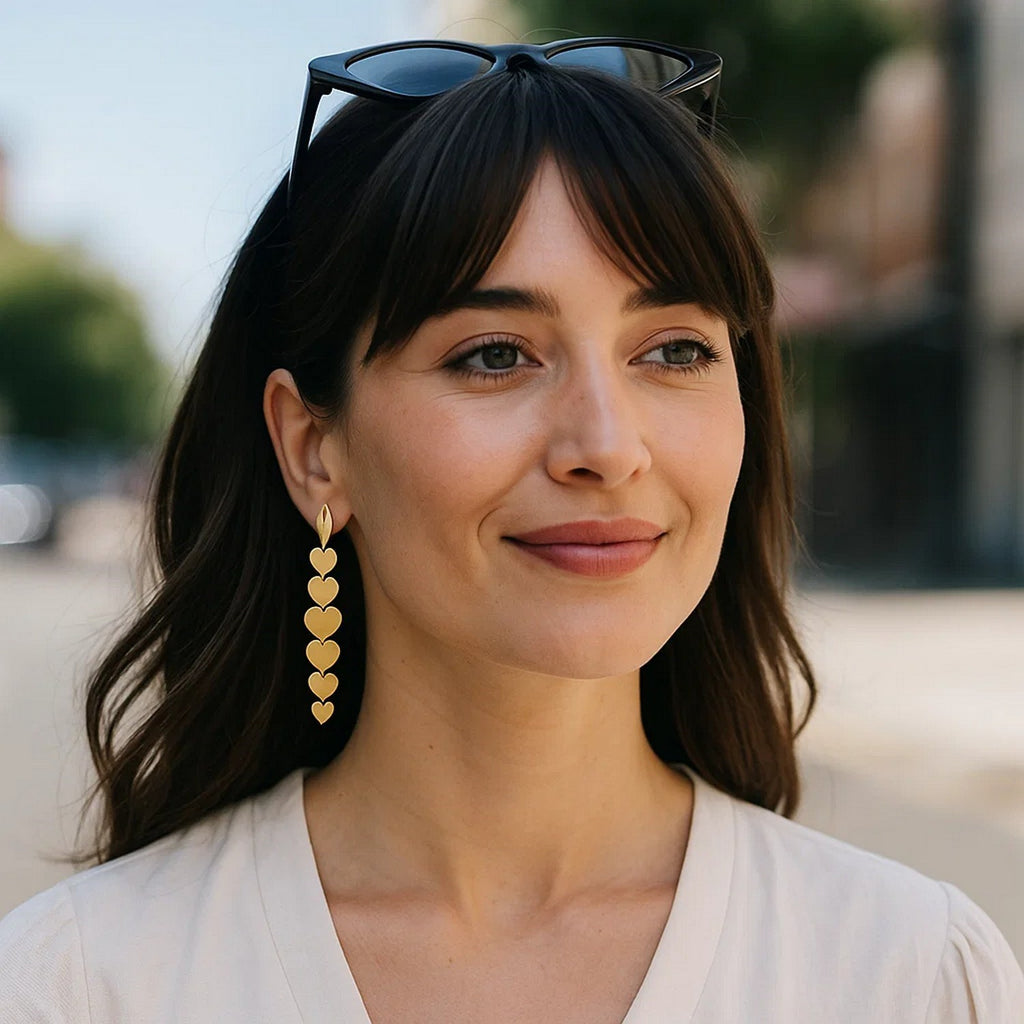Elegant 14k yellow gold heart drop earrings showcasing a refined design and luxurious finish for a timeless look.