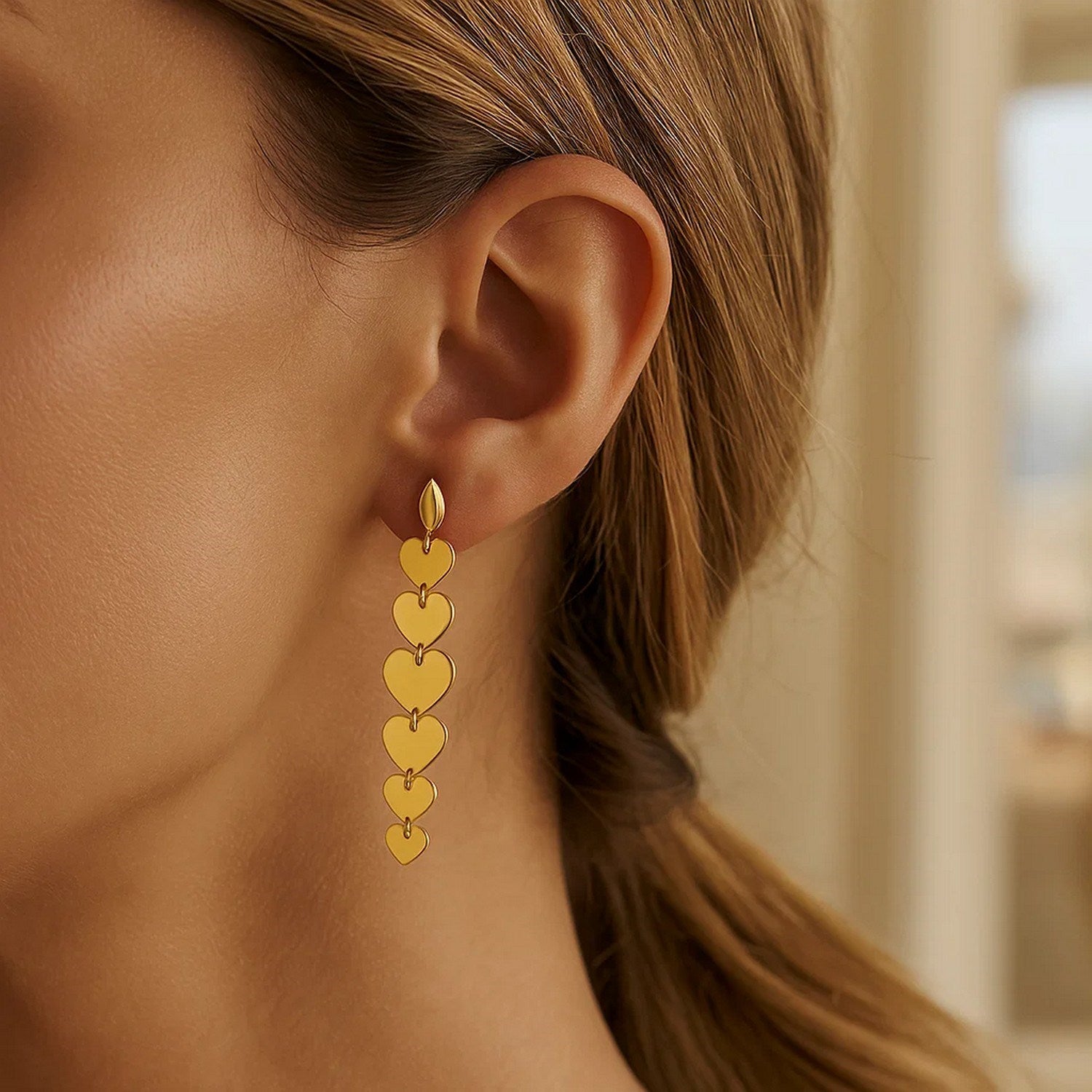 Elegant 14K yellow gold heart drop earrings showcasing a refined design and luxurious craftsmanship.