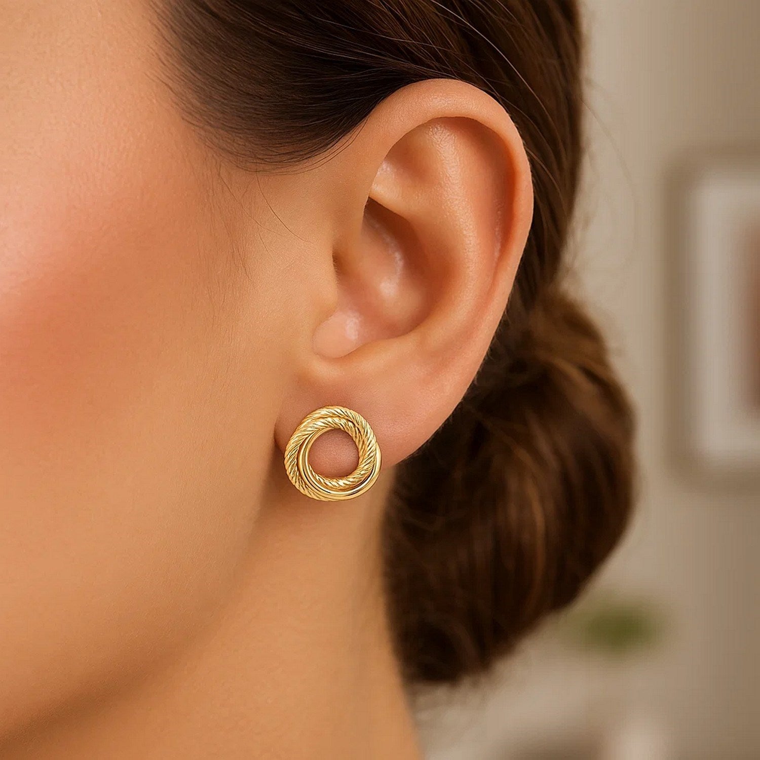 14K yellow gold diamond cut interlocking stud earrings with modern design and exquisite sparkle.