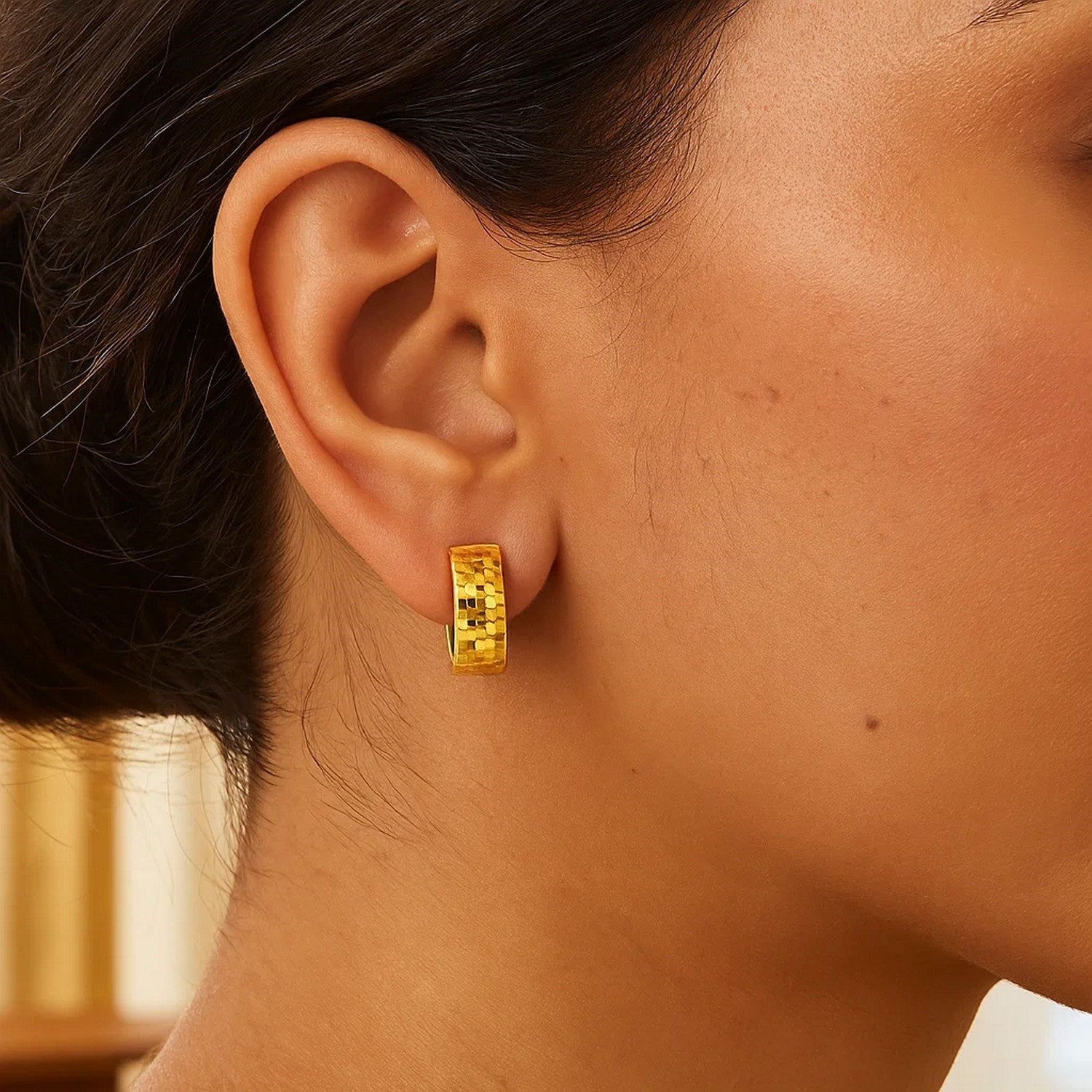 14k yellow gold textured and polished hoop earrings adorned with sparkling diamonds, showcasing contemporary elegance.