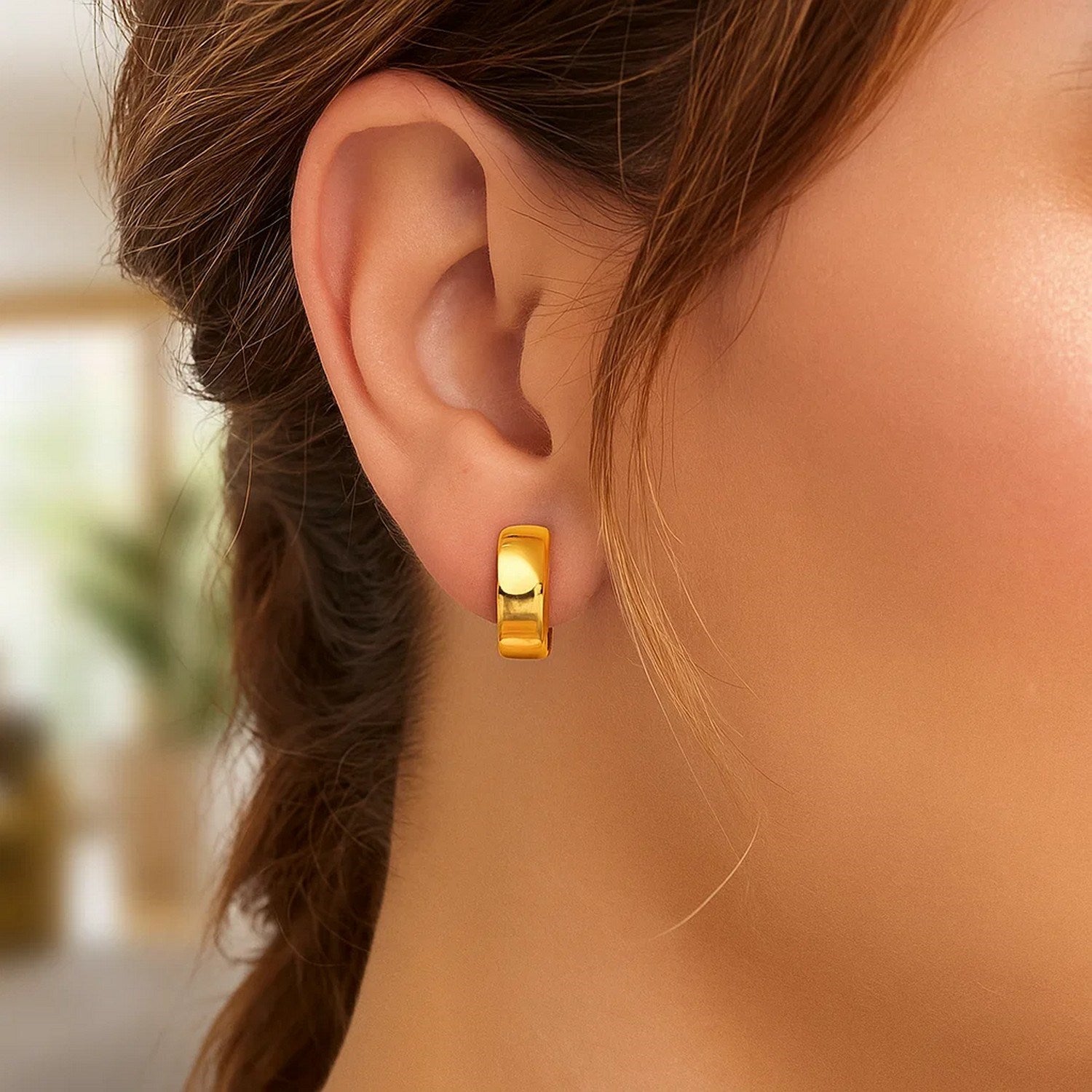 14k yellow gold textured and polished hoop earrings adorned with sparkling diamonds, showcasing contemporary elegance.