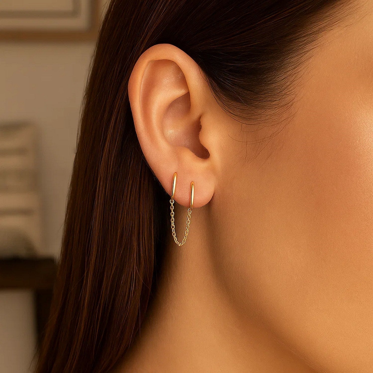 14k yellow gold modern huggie hoop earrings featuring a sleek two-hole design for effortless elegance.