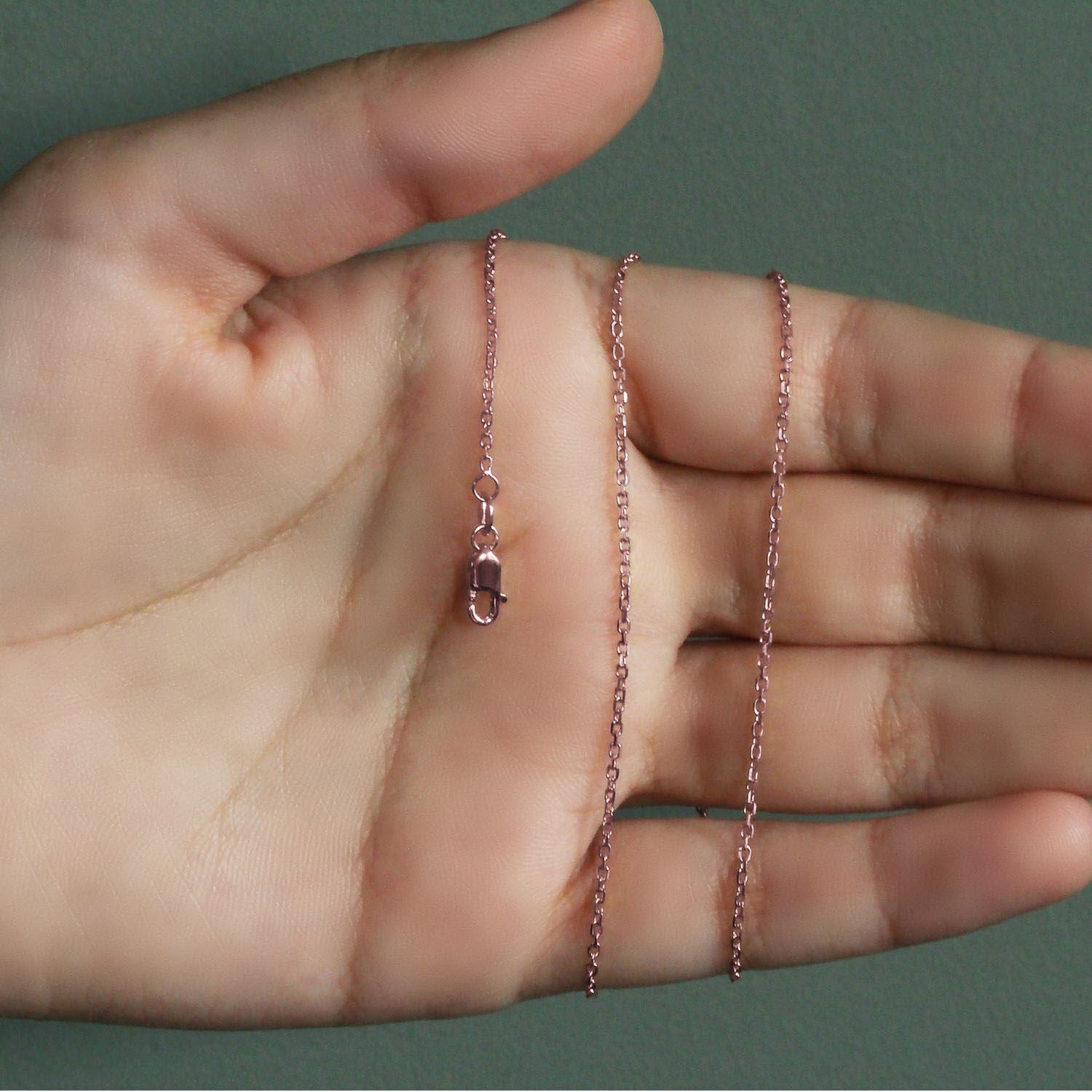 14k rose gold diamond cut cable link chain with modern design, showcasing elegant interlocking links.