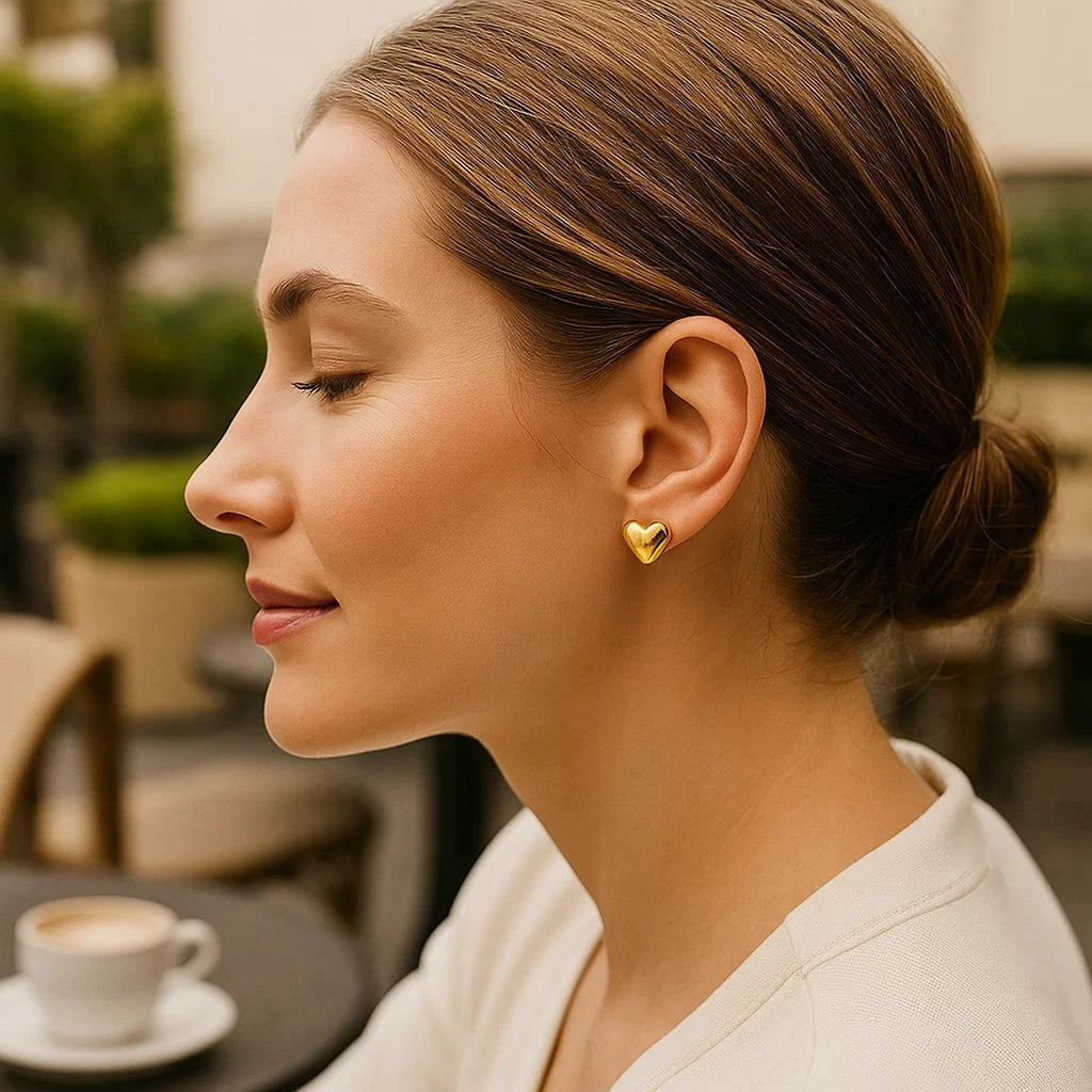 Elegant 14k yellow gold puffed heart stud earrings, showcasing a timeless design perfect for any occasion.