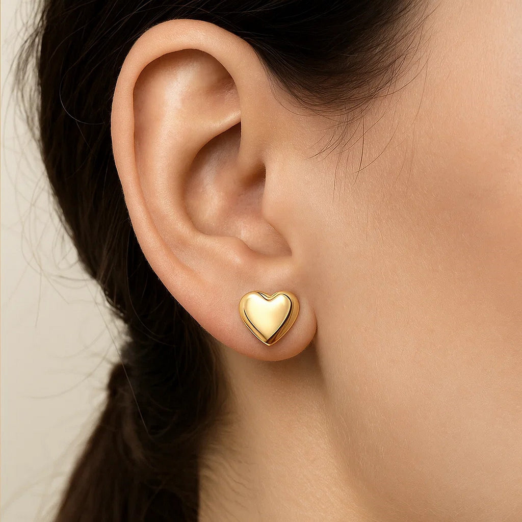 Elegant 14k yellow gold puffed heart stud earrings, showcasing a refined design perfect for any occasion.