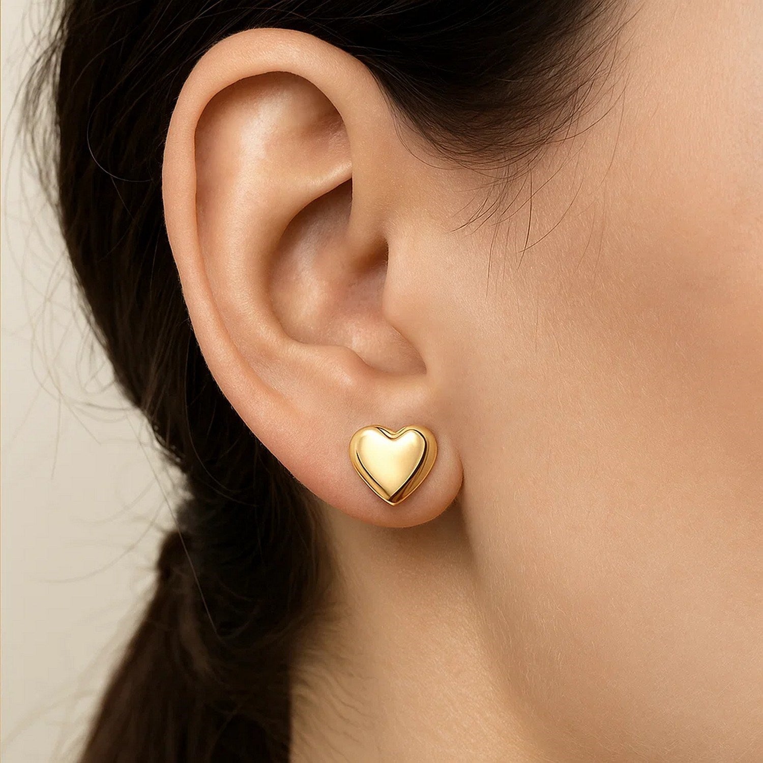 Elegant 14k yellow gold puffed heart stud earrings, showcasing a refined design perfect for any occasion.