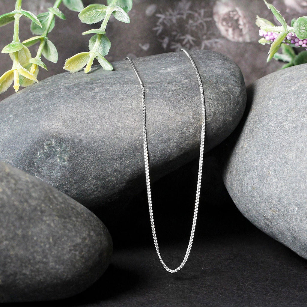 Elegant 14k white gold round wheat chain, 0.80 mm, showcasing a refined, timeless design for luxury jewelry enthusiasts.