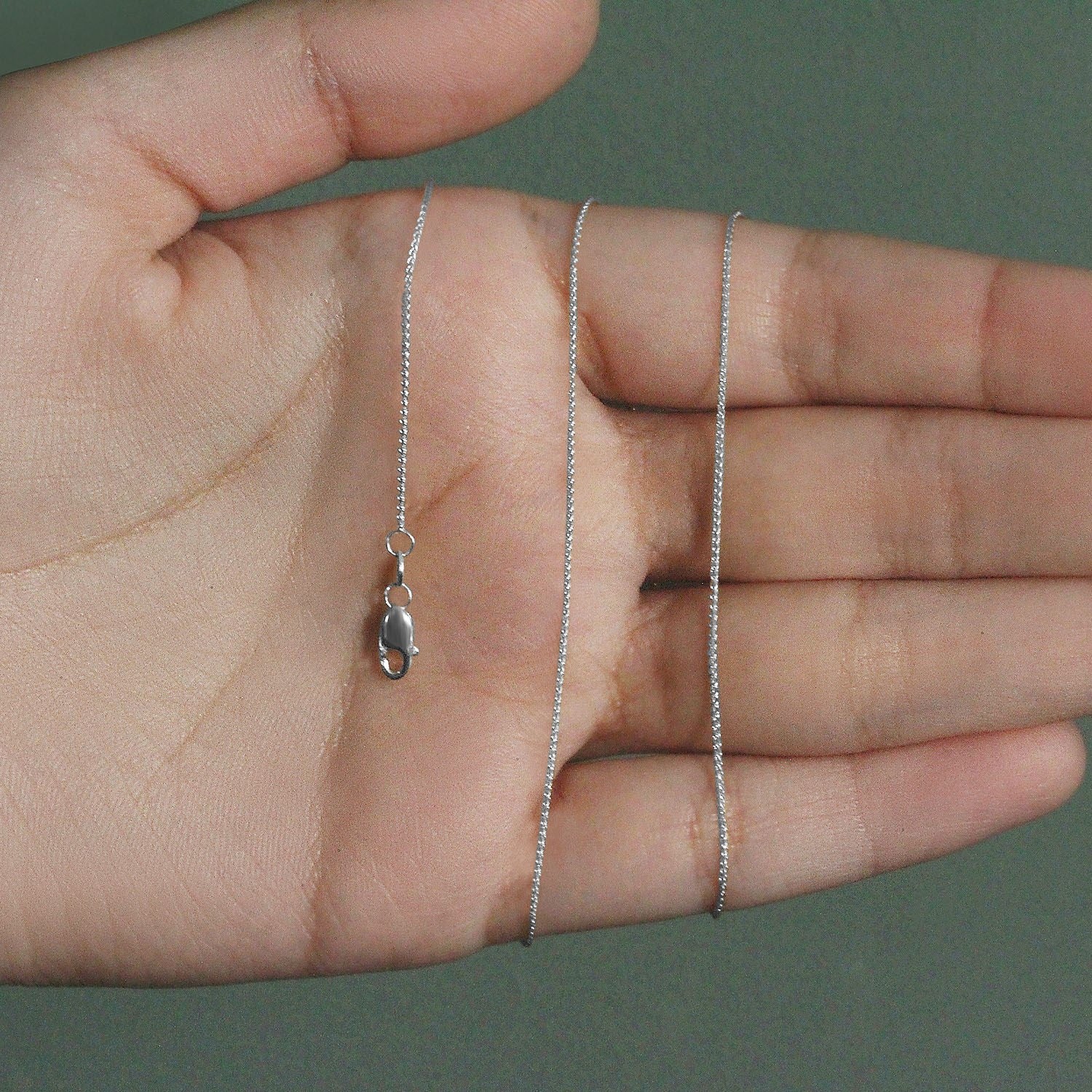 Elegant 14k white gold round wheat chain, 0.80 mm, showcasing a refined and timeless design for luxury jewelry lovers.