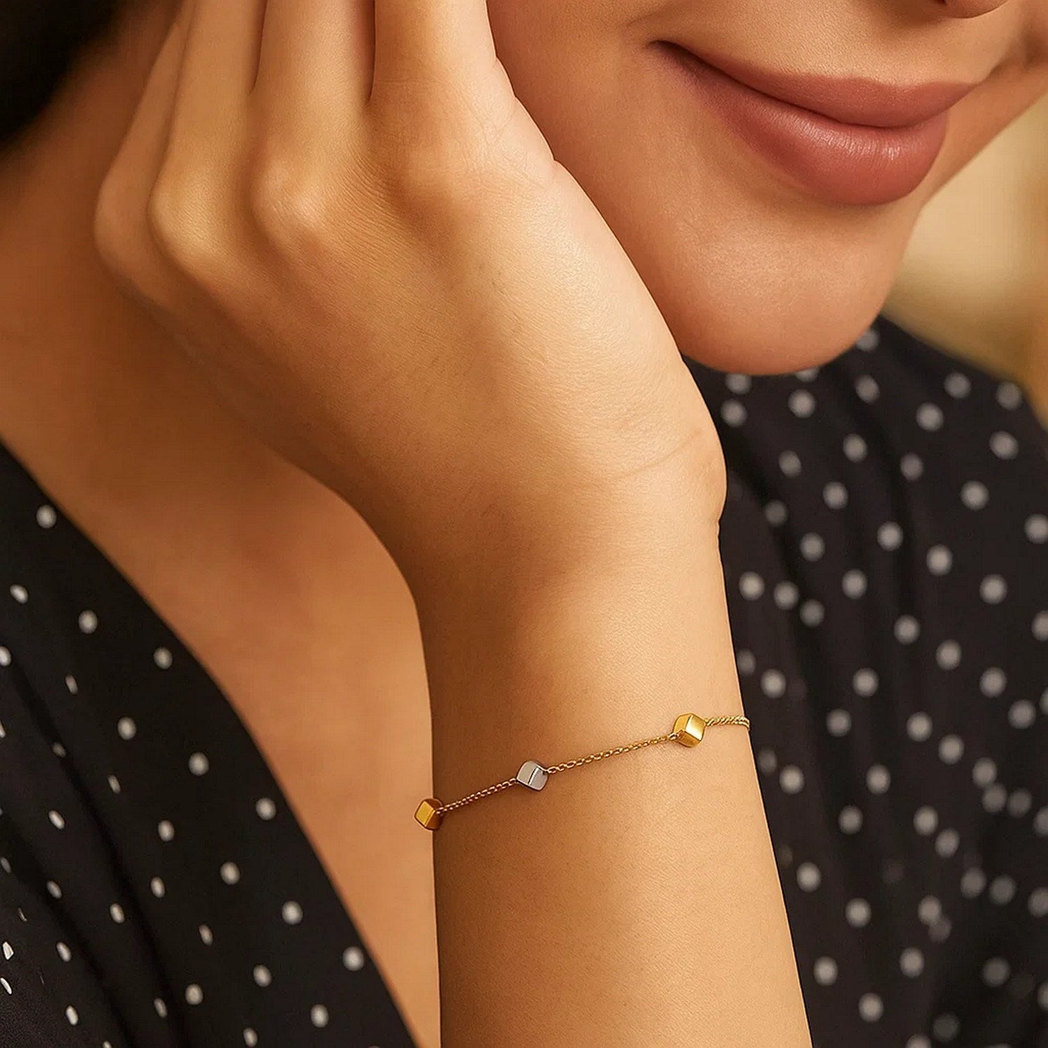 14k two-tone gold bracelet featuring polished cubes on a modern chain design, perfect for luxury styling.
