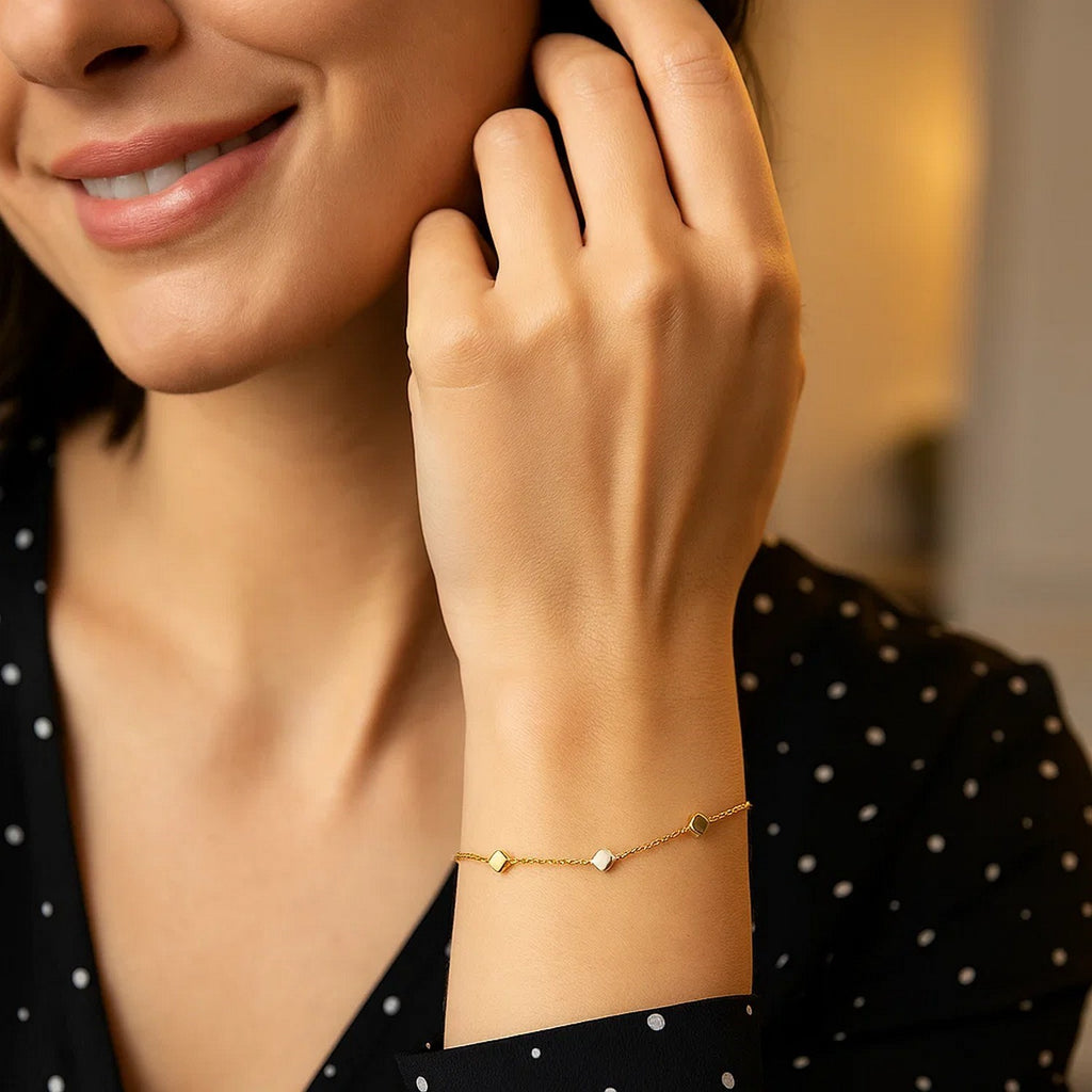 14k two-tone gold bracelet featuring polished cubes and a modern chain design, perfect for elegant styling.