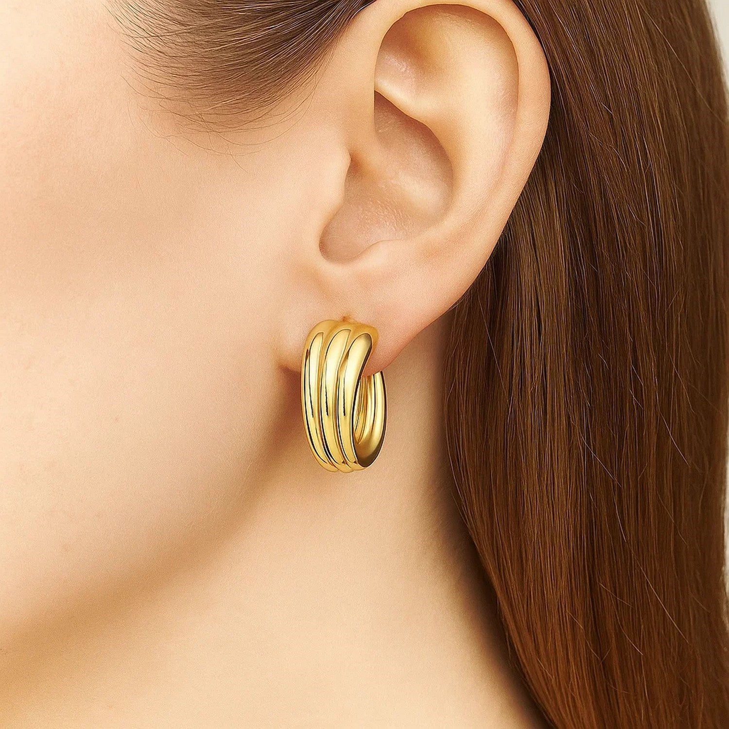14k yellow gold graduated 3 row hoop earrings with a modern design, perfect for elegant occasions and everyday wear.