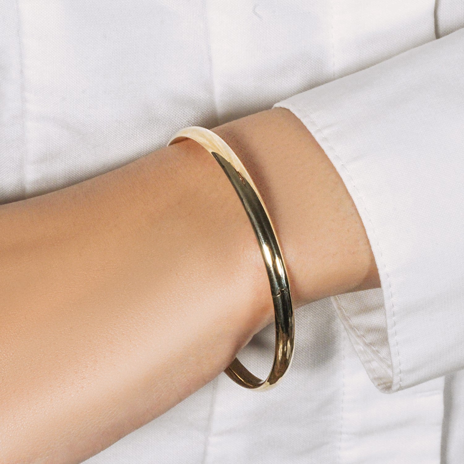 Elegant 10k yellow gold dome bangle, 3.30 mm, showcasing a luxurious shiny finish and refined design.