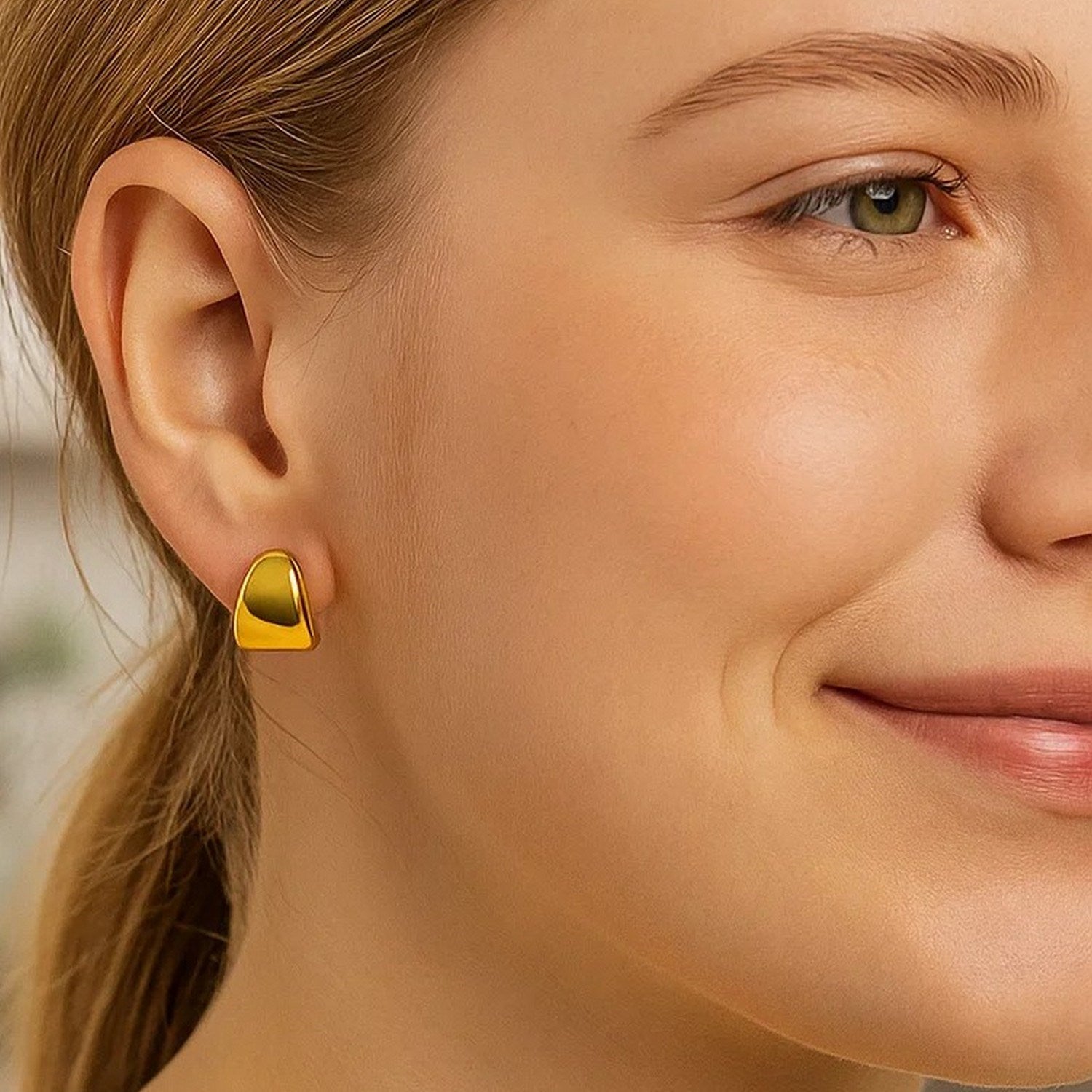 14K yellow gold polished graduated hoop earrings showcasing a modern design and luxurious shine.