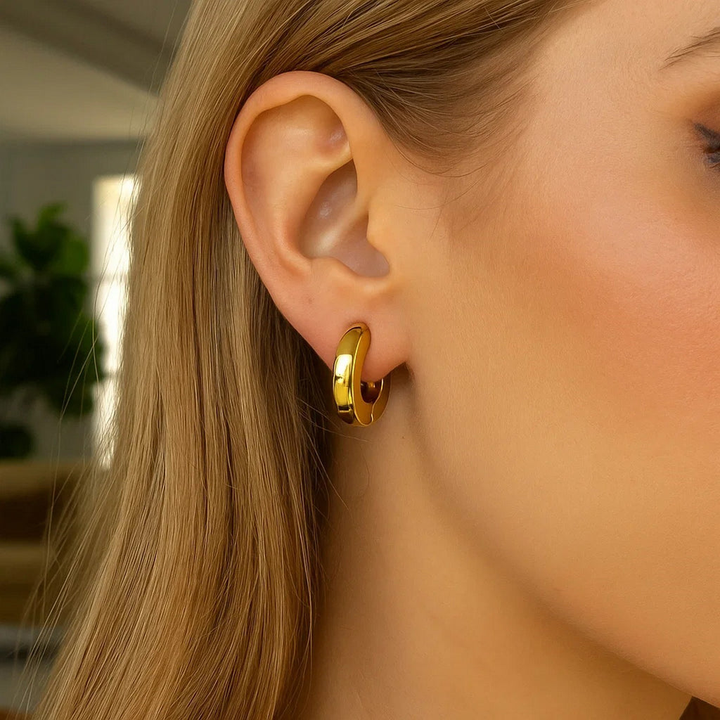 14k yellow gold thick hoop earrings showcasing a modern design, perfect for elegant everyday wear.