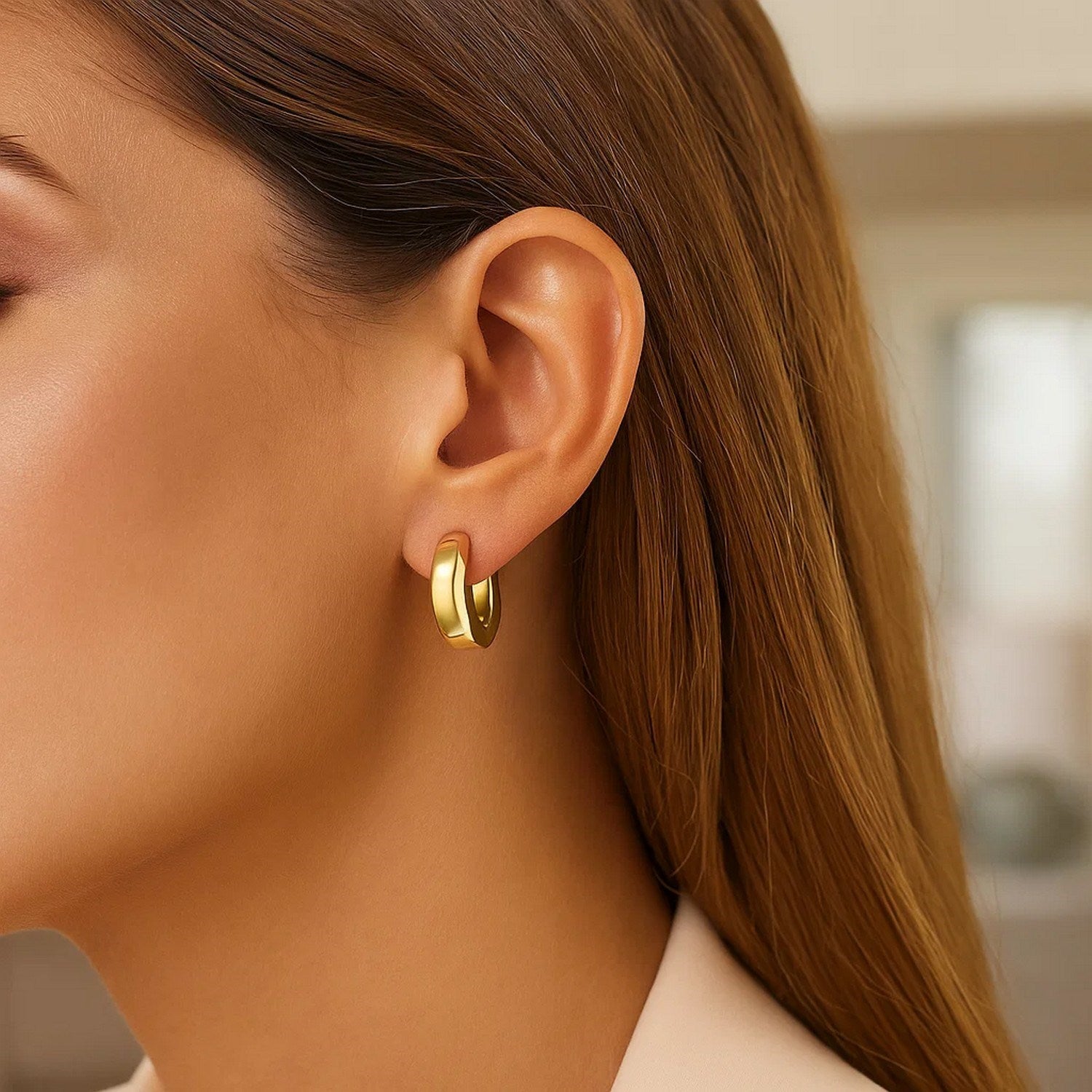 14k yellow gold thick hoop earrings with a modern design, perfect for adding elegance to any outfit.