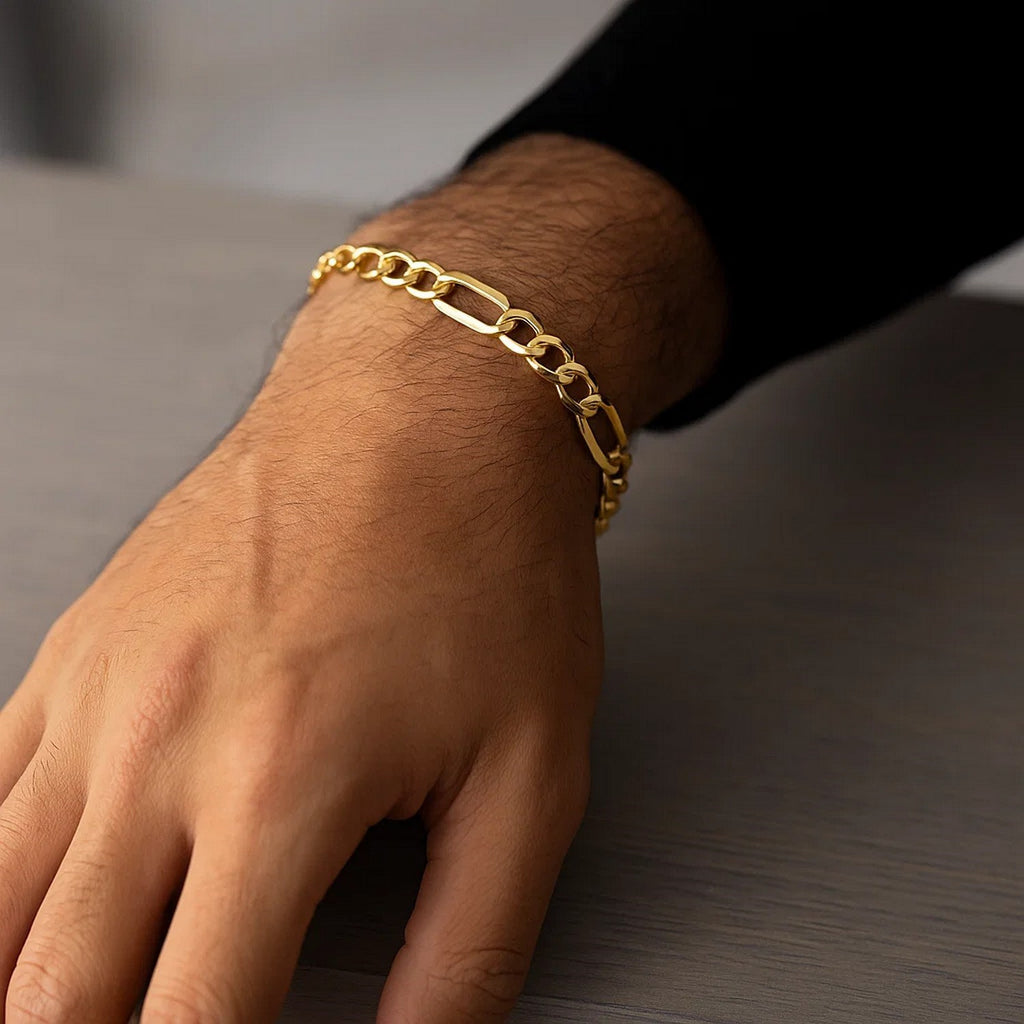 14k yellow gold Lite Figaro bracelet with modern chain links, showcasing elegance and timeless luxury.