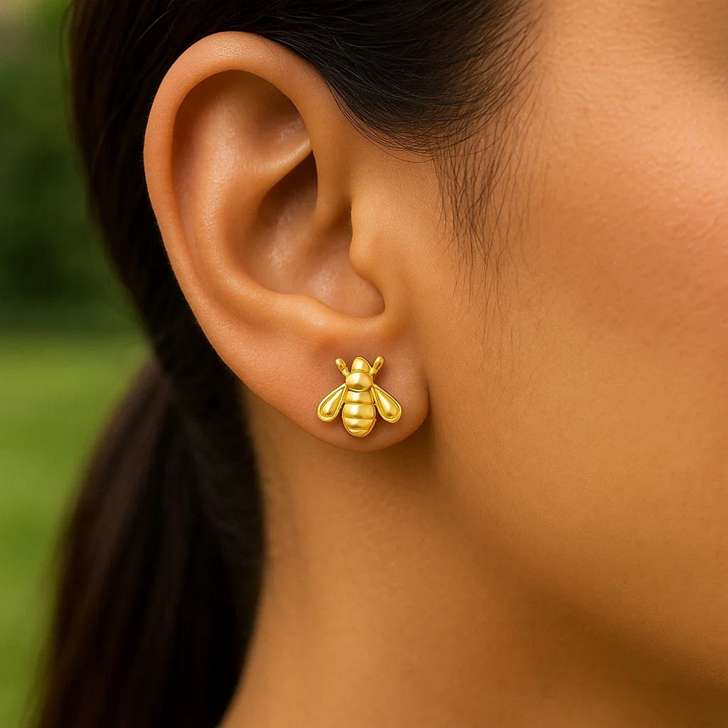 Elegant 14k yellow gold bee stud earrings showcasing intricate detailing and a timeless design for luxury enthusiasts.