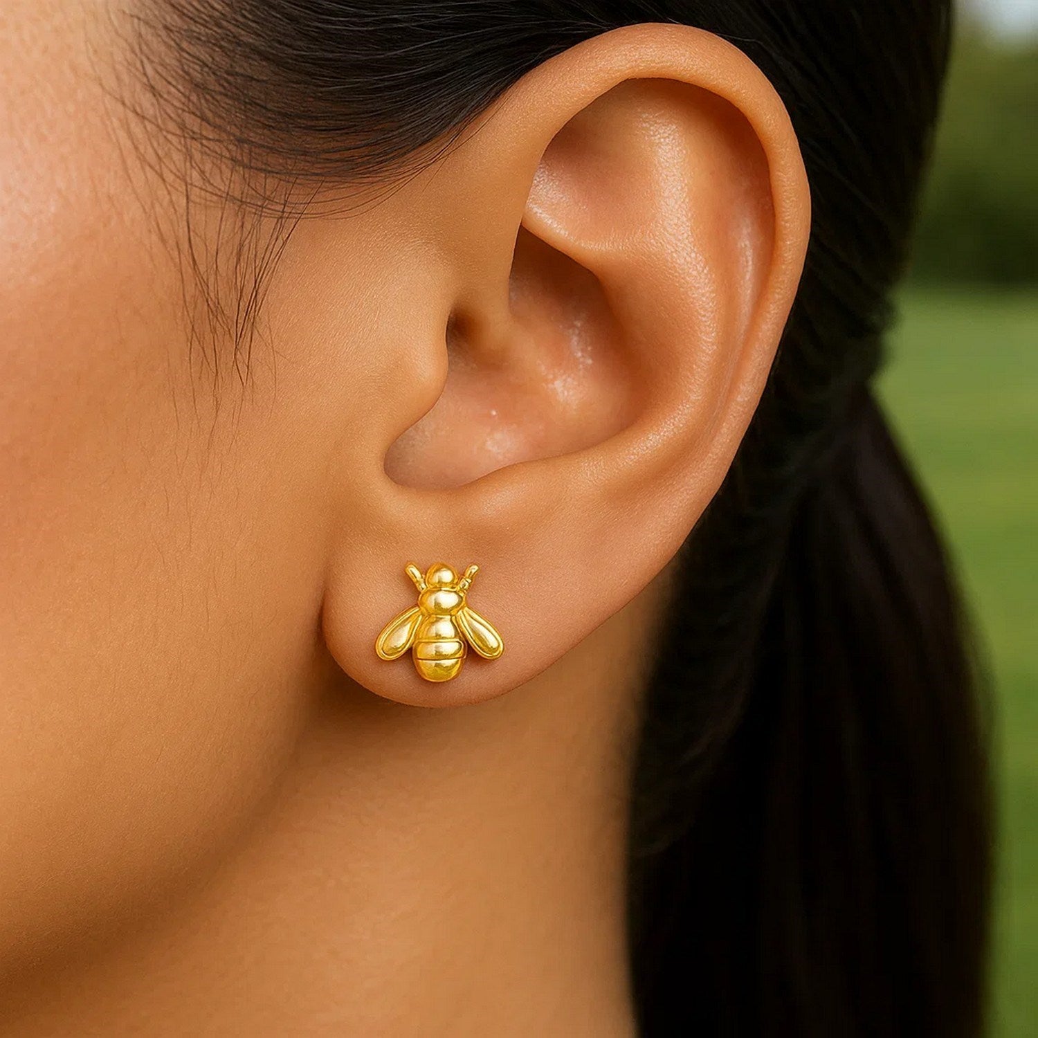 Elegant 14k yellow gold bee stud earrings showcasing intricate design and luxurious craftsmanship.